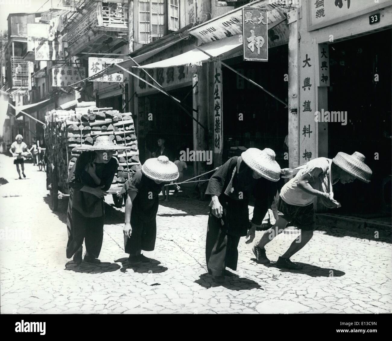 Mar. 02, 2012 - Macao women haul a heavy cart loaded with fire wood through the city streets. Stock Photo