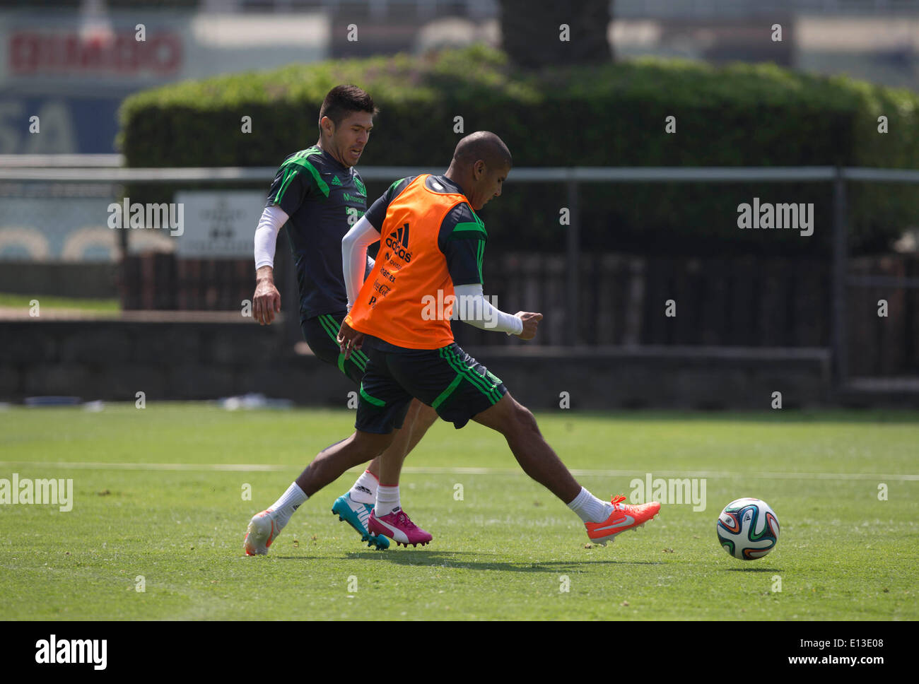 Mexico City. 21st May, 2014. Mexican National Team players Oribe Peralta (L) and Carlos Salcido take part in a training session at the High Performance Center of the Mexican Soccer Federation in Mexico City, on May 21, 2014. Mexico will have a friendly match with Israel on May 28 before the FIFA World Cup. © Sandra Perdomo/Xinhua/Alamy Live News Stock Photo