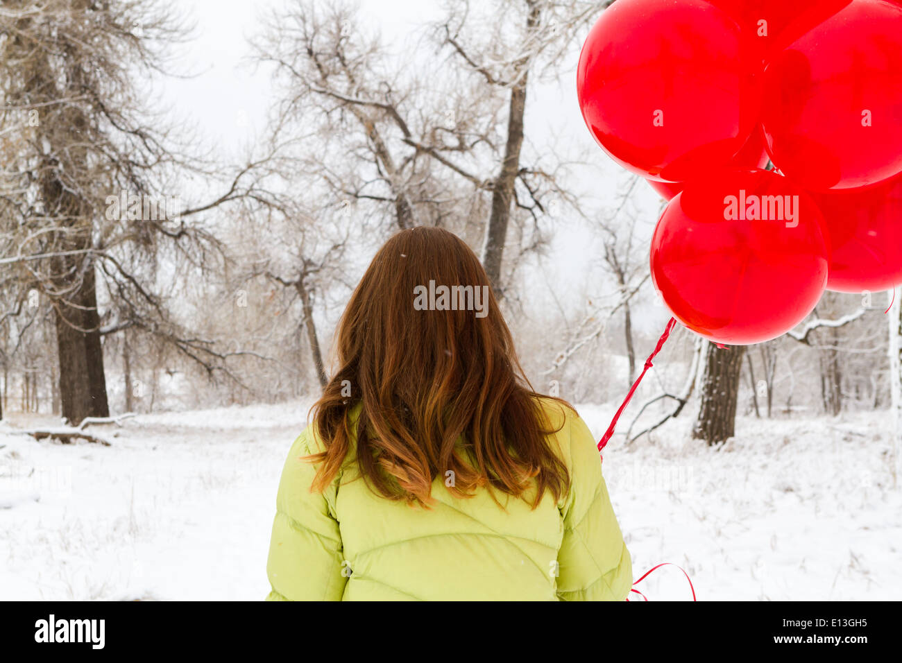 Teenager girl with red balloons walking in the park Stock Photo - Alamy