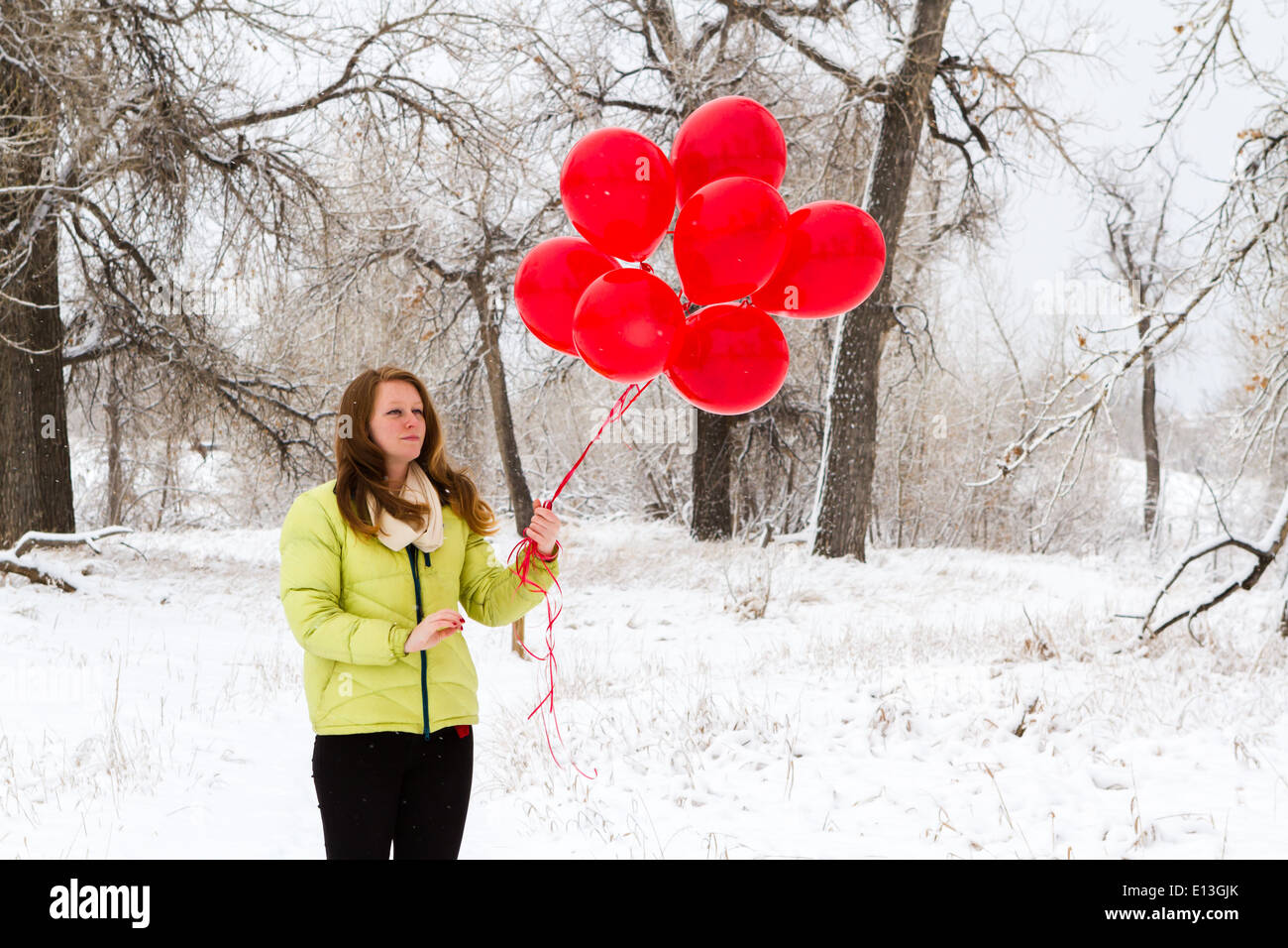 Teenager girl with red balloons walking in the park Stock Photo - Alamy