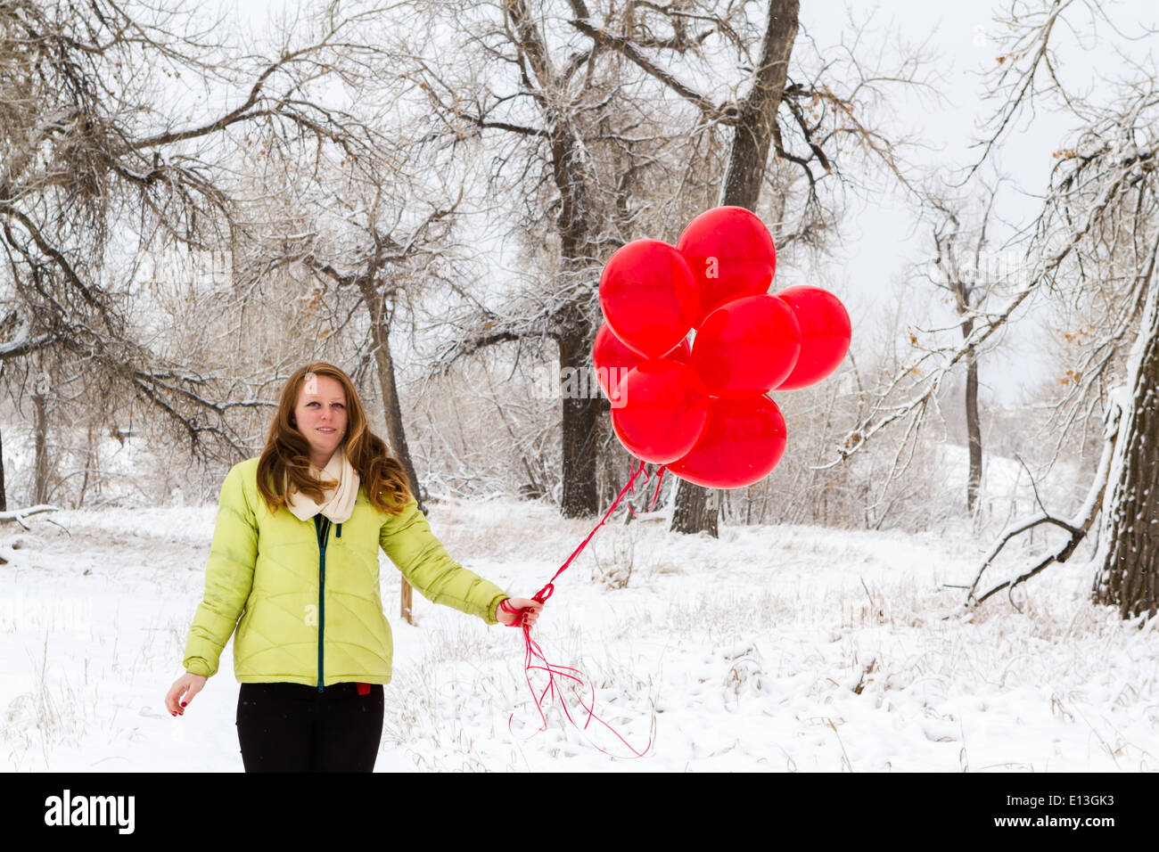Teenager girl with red balloons walking in the park Stock Photo - Alamy