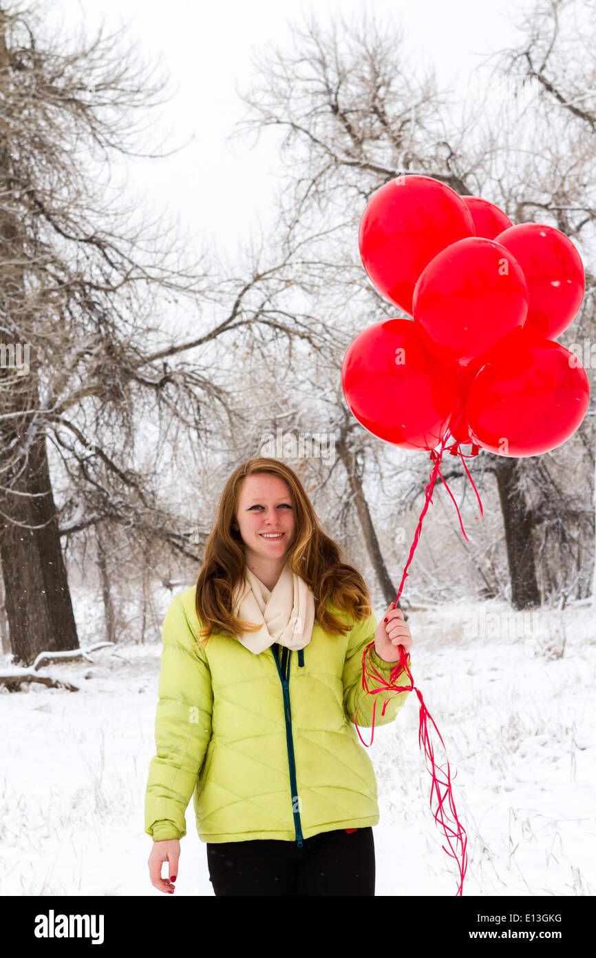 Teenager girl with red balloons walking in the park Stock Photo - Alamy