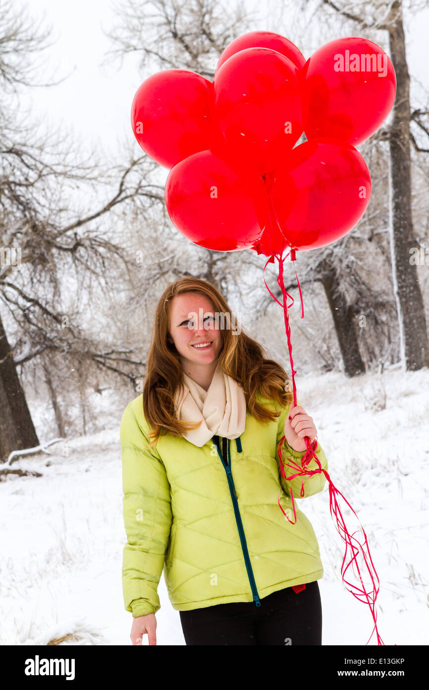 Teenager girl with red balloons walking in the park Stock Photo - Alamy