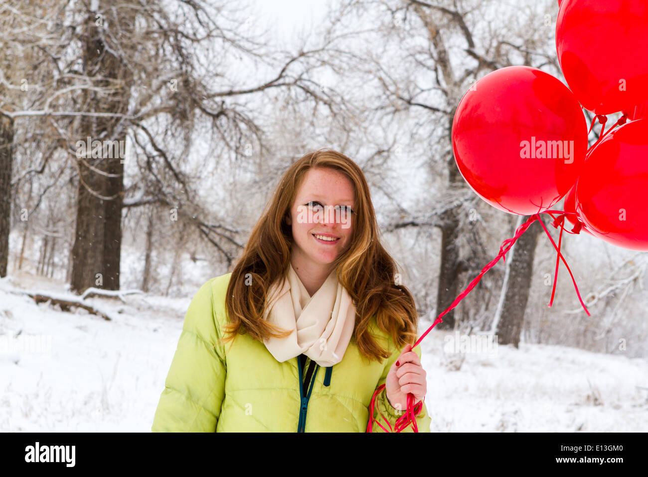 Teenager girl with red balloons walking in the park Stock Photo - Alamy