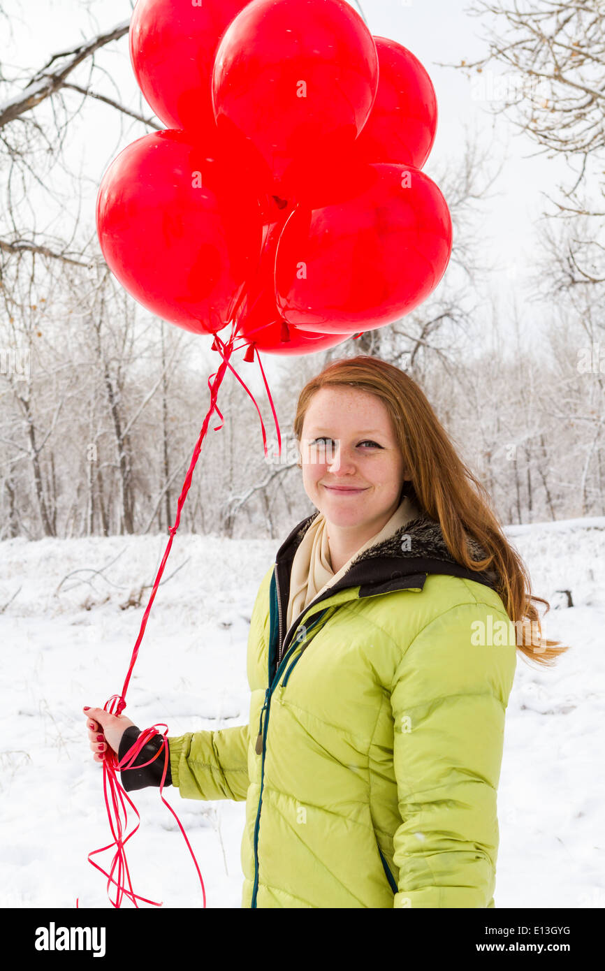 Teenager girl with red balloons walking in the park Stock Photo - Alamy
