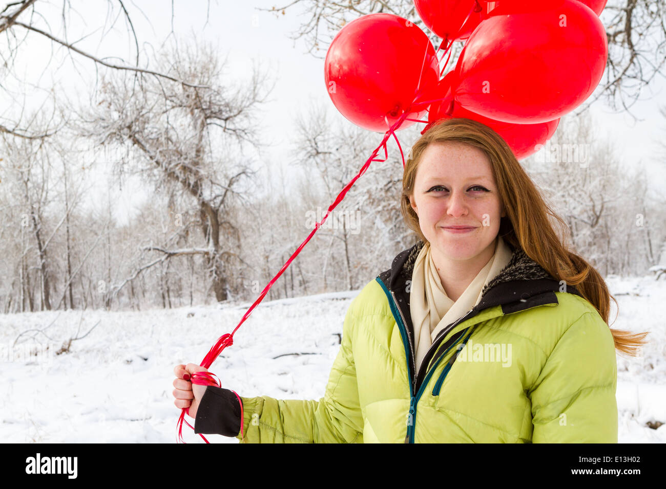 Teenager girl with red balloons walking in the park Stock Photo - Alamy