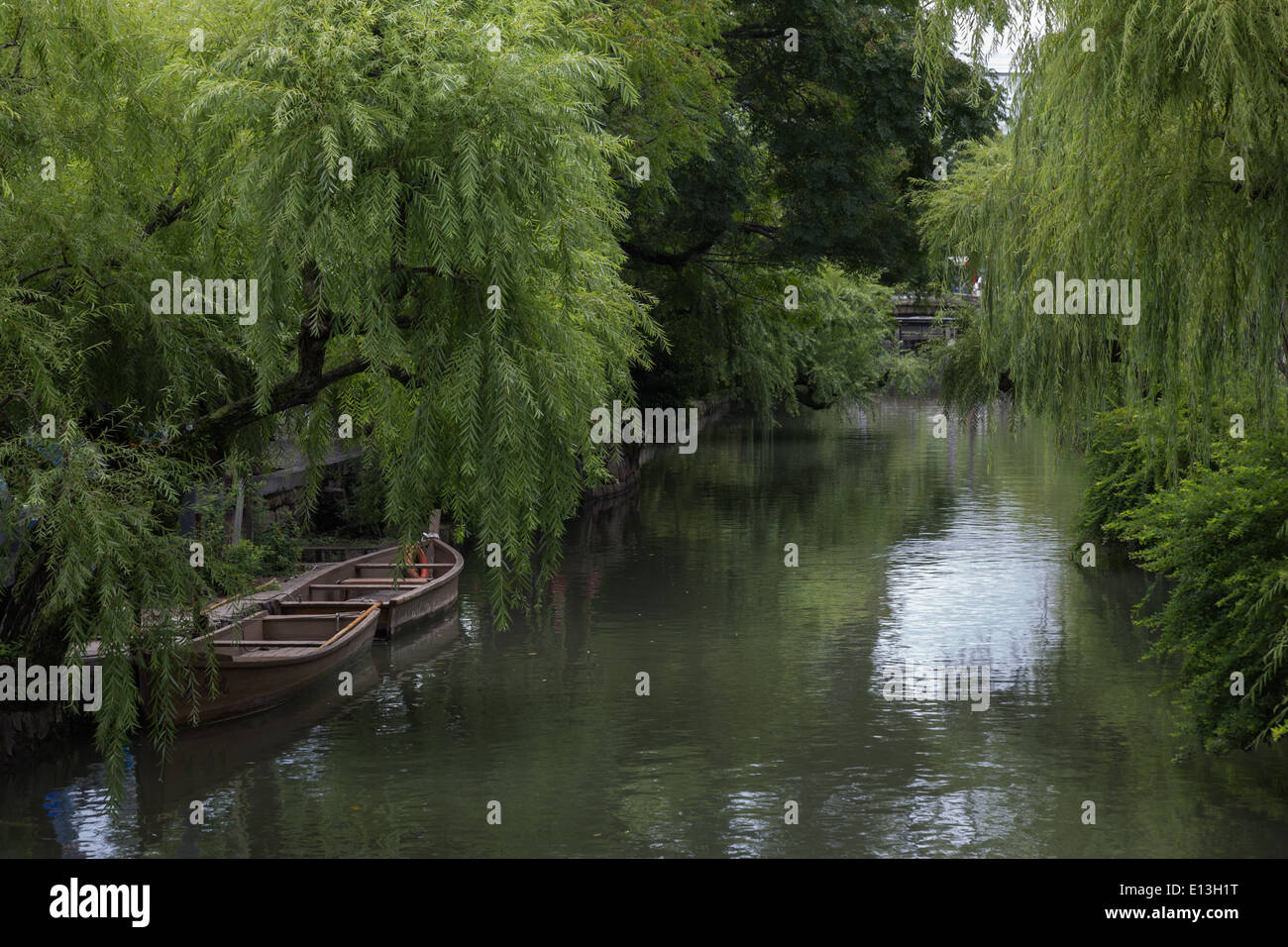 Weeping willow trees line the main canal in the old town of Kurashiki
