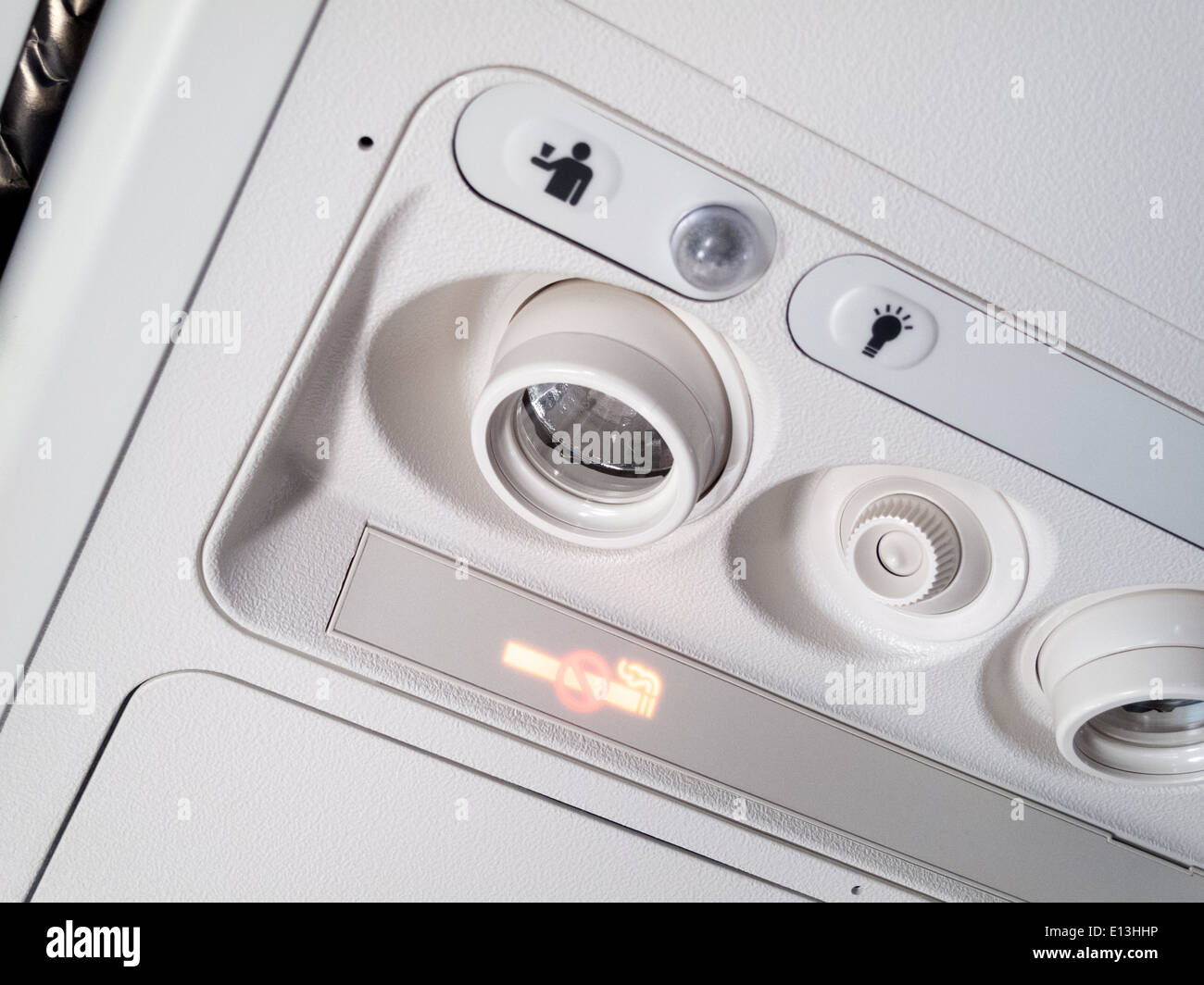 air conditioner lamps and no smoking sign in an airplane stock