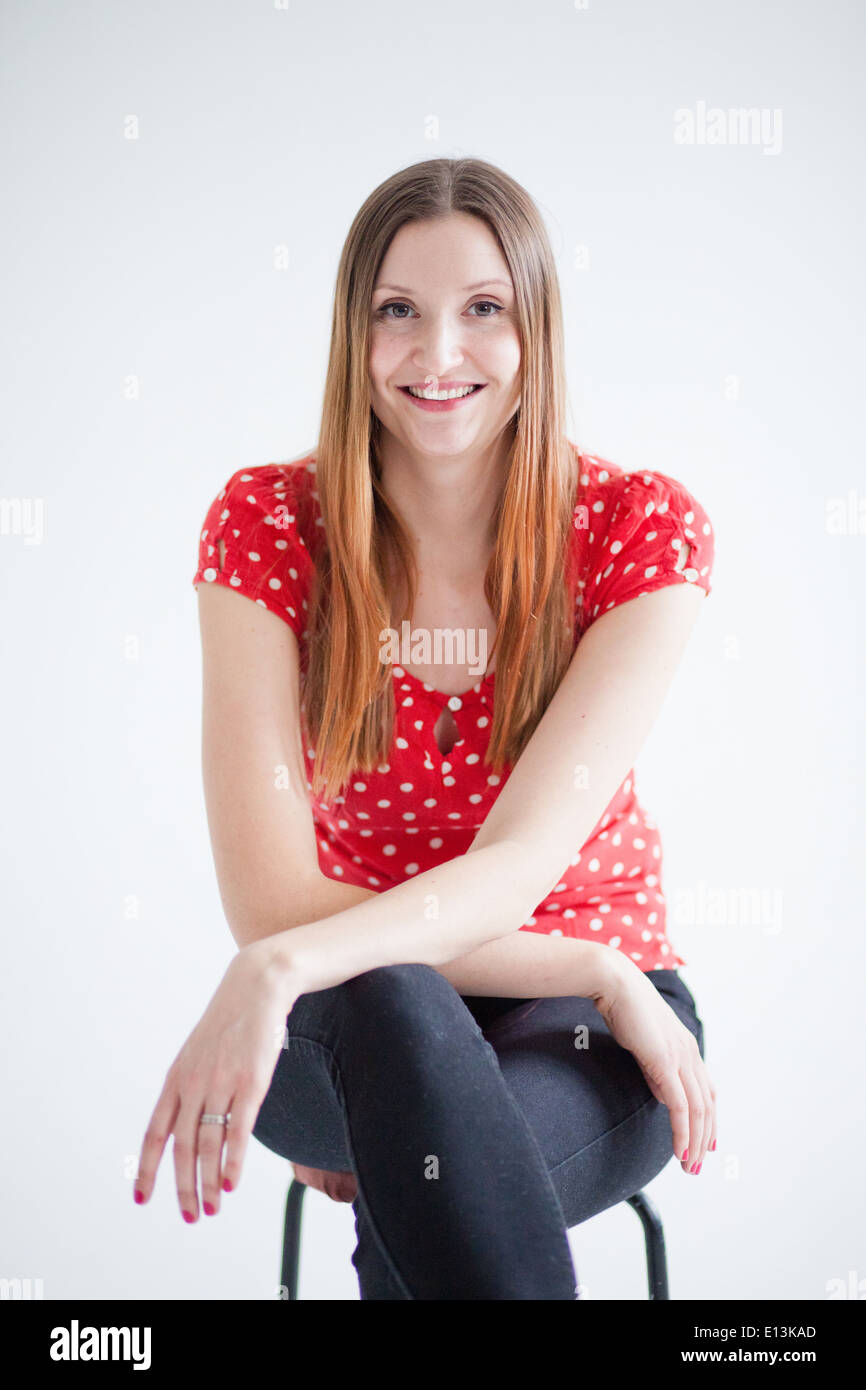 Woman sitting on stool red hi-res stock photography and images - Alamy