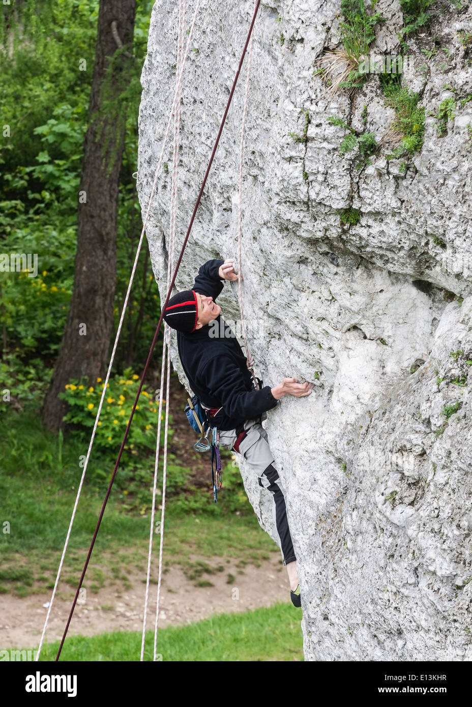 Man climbing rocky wall. Stock Photo