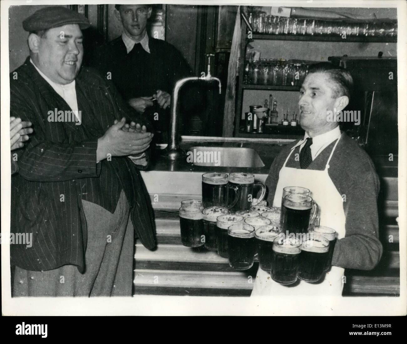 Mar. 02, 2012 - Vienna Innkeeper Claims World Pot Carrying Championship Twenty-Two At A Time: Vienna Innkeeper Karl Schulz was very annoyed when he learned that the title ''World Pot Carrying Championship'' had been given to New York Waiter Max Semmer - as he was able to carry sixteen pots at one time. Karl proves that he is able to carry a table of Twenty-Two post at the time - in the Correct manner. Karl who learned the art as a waiter apprentice of the ''Deutsches Haus'' in Bruenn - where he and his ten colleagues rivaled in the art of carrying pots - and he easily outstripped the rest. Stock Photo