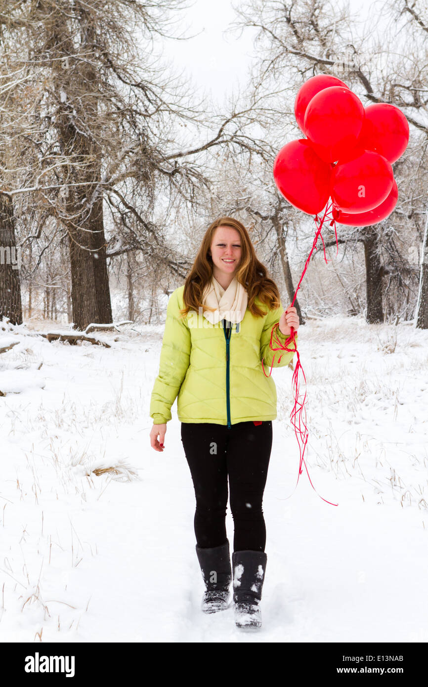Teenager girl with red balloons walking in the park Stock Photo - Alamy
