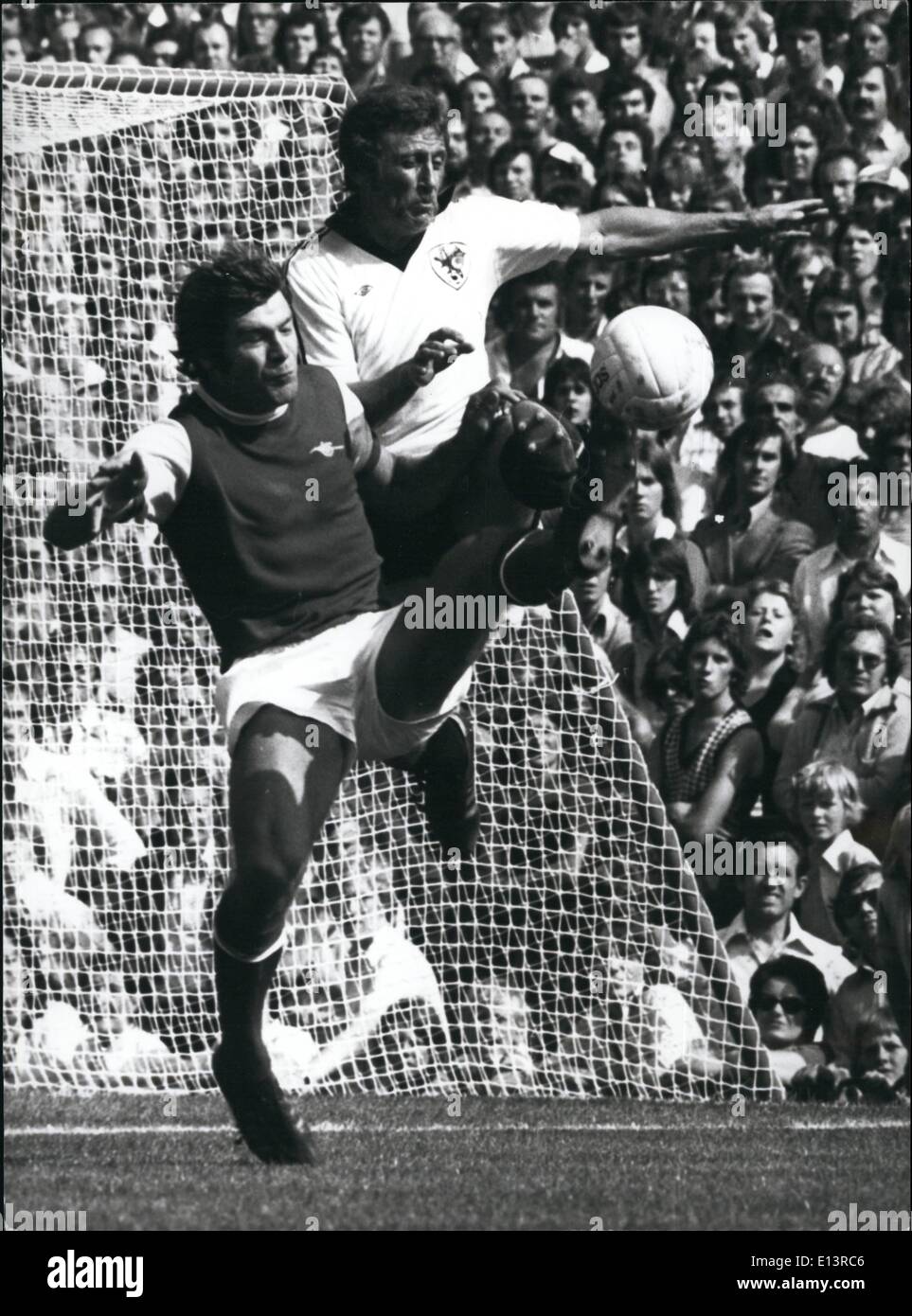 Mar. 27, 2012 - Toling It.: Malcolm MacDonald (Arsenal) reaches the ball with his toe 5 feet above the ground. In close attendance is Bristol City's Geoff Merrick. Stock Photo