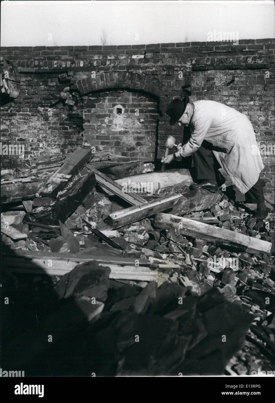 Mar. 27, 2012 - Looking for potential beauty. Mr. Kern searches amongst the rubble for a suitable material. Stock Photo