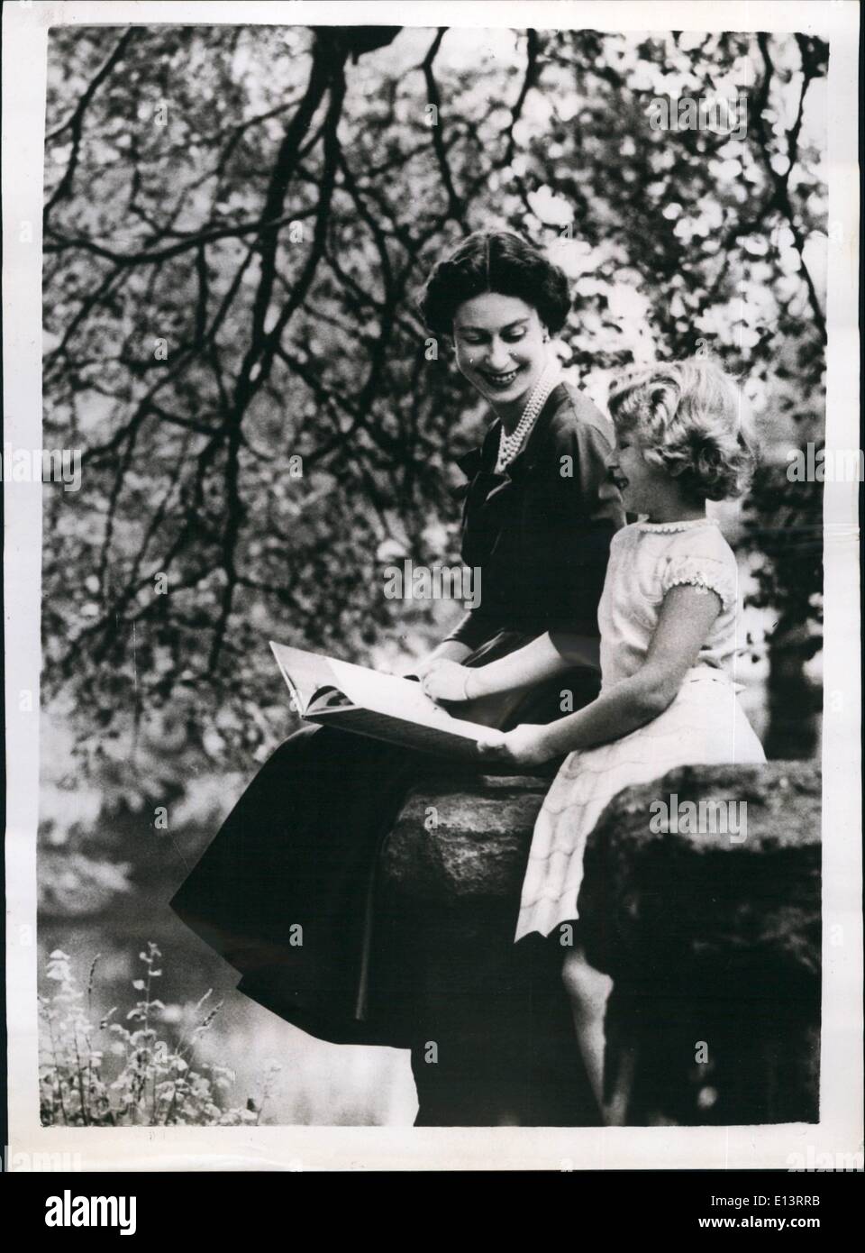 Mar. 27, 2012 - Seventh birthday of H.R.H. Princes Anne. Picture in grounds of Buckingham Palace: Princess Anne is pictured with her mother H.M. The Queen Elizabeth II, in the ground of Buckingham Palace. The Princess, whose seventh birthday is celebrated on 15th. August - is wearing a pale green dress trimmed with pink and white. the Queen is wearing a sapphire blue silk afternoon dress with four rows of pearls. Stock Photo