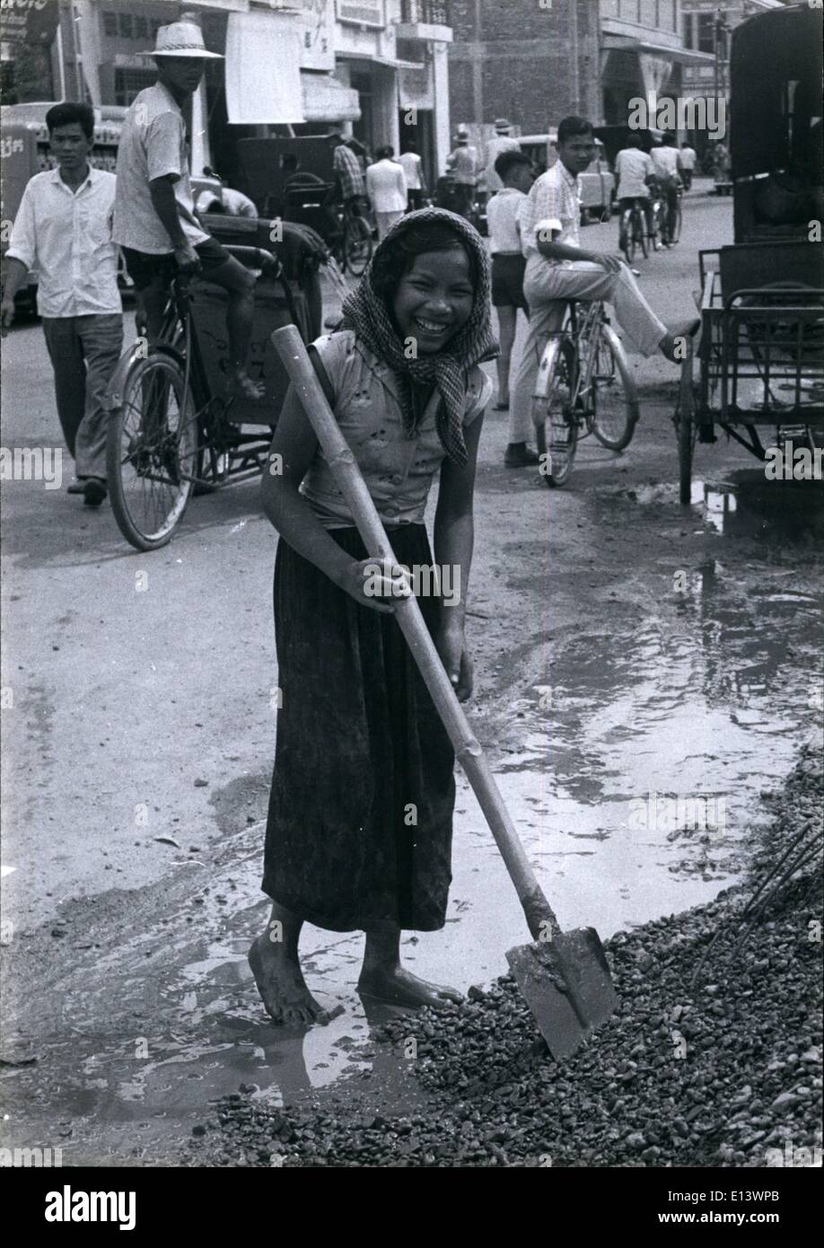 Mar. 27, 2012 - A girl labourer of Phnon-Penh who is employed mixing pebbles with cement, despite her hard work she has a smile Stock Photo