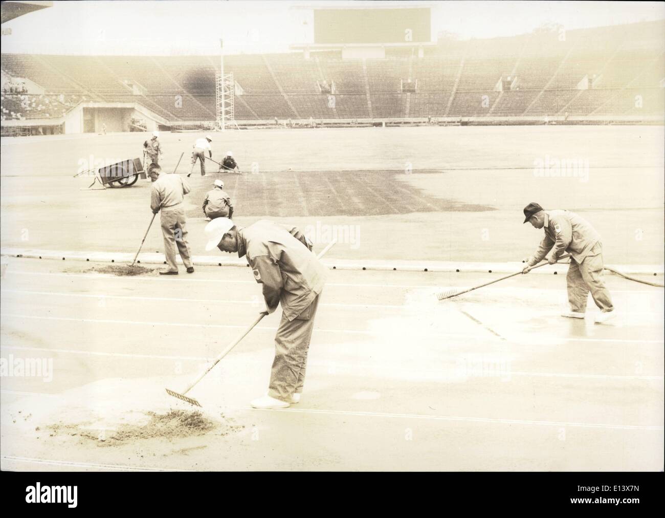 Mar. 27, 2012 - Near Disaster at Tokyo Olympics.: Workmen are trying to save the track at the National Stadium by repairing the Stock Photo