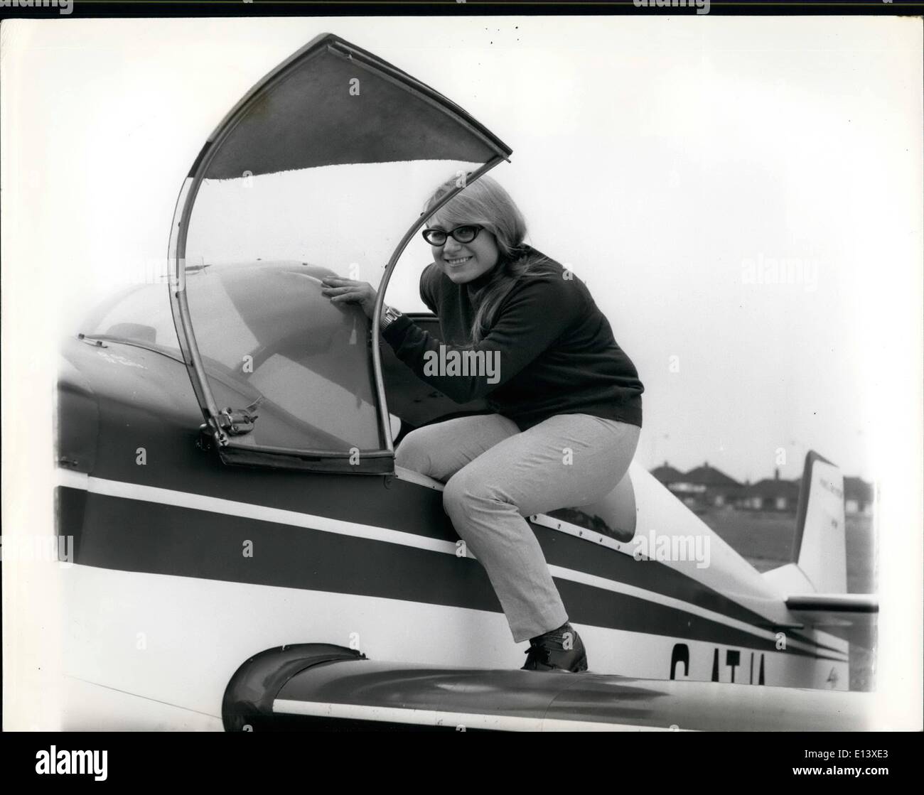 Mar. 27, 2012 - Rosalinda climbs into the cockpit for a spin at Rochester Airport. A confident smile for the photographer before she takes off. Stock Photo