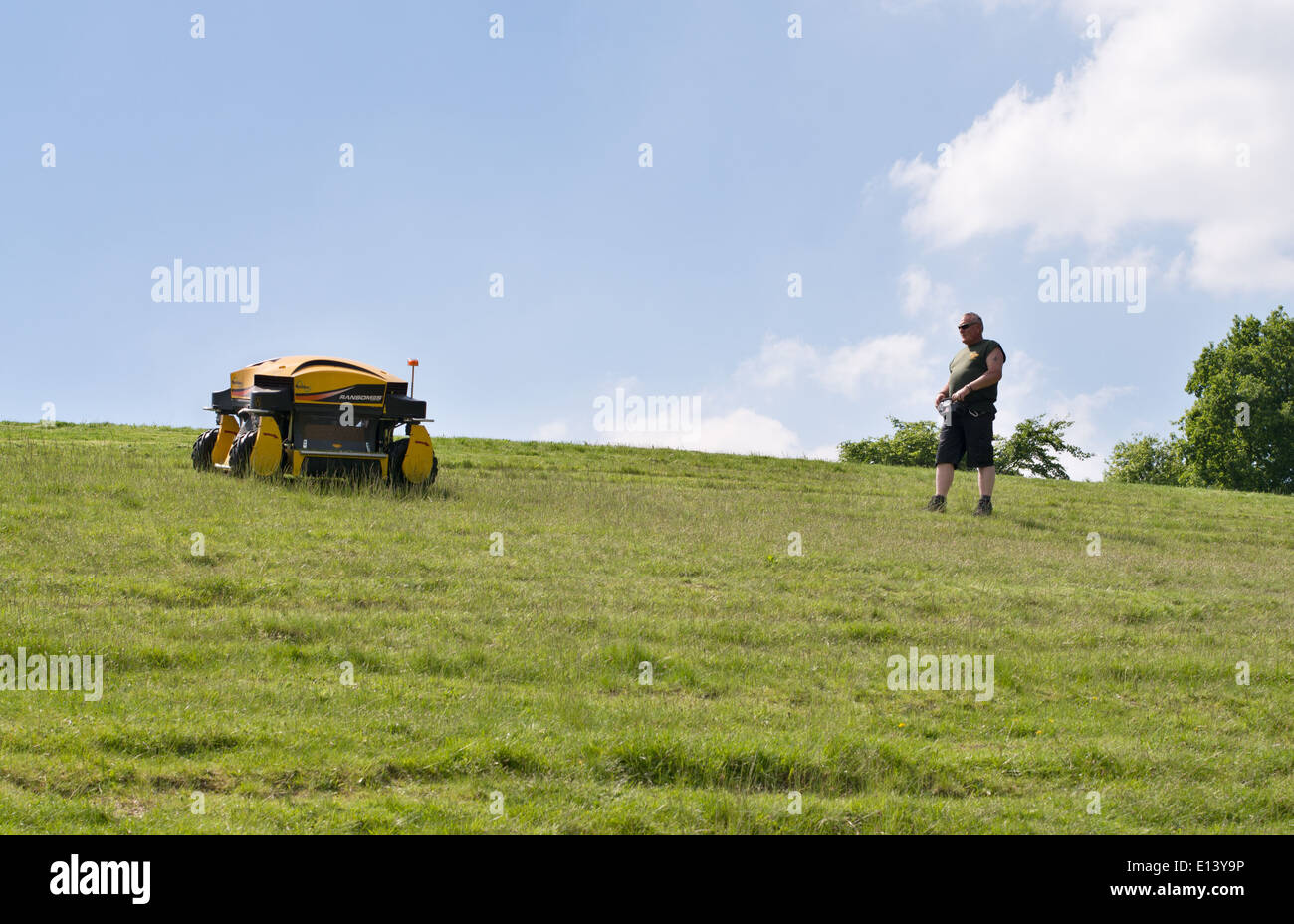 Gardener using a radio controlled Ransomes Spider remote control banks mower Roundhay Park, Leeds, England UK Stock Photo
