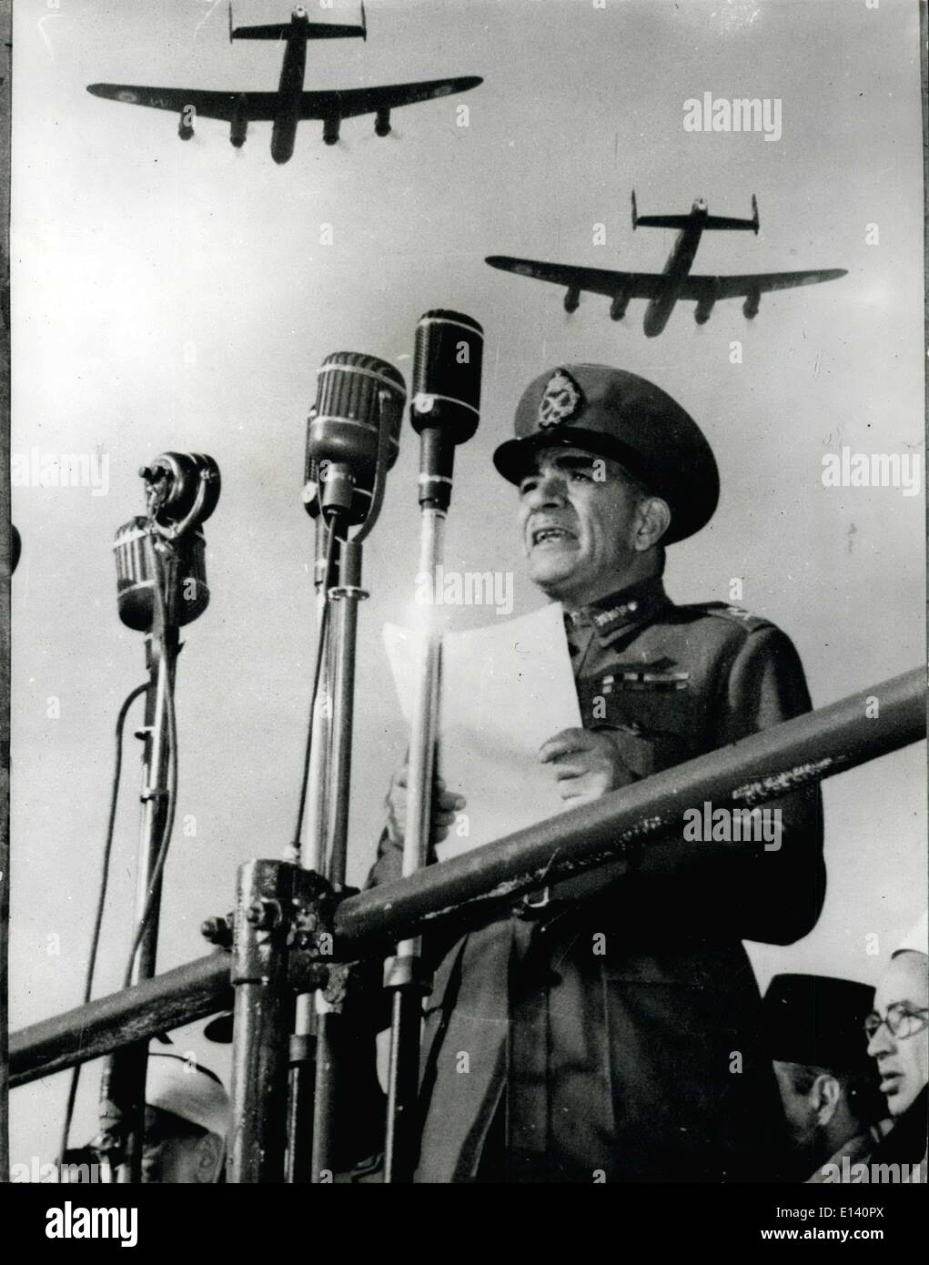 Mar. 31, 2012 - GENERAL NEGUIB MAKES HIS ''SUDAN IS OURS'' SPEECH.. PLANES OVERHEAD DURING ''LIBERATION'' CELEBRATIONS GENERAL NEGUIB the Dictator-Premier of Egypt proclaimed ''Liberation Front'' to replace the country's dissolved political parties...During his speech Neguib shouted''Sudan Is Ours''-a statement that was greeted with cheers-booming guns etc..by the 100,000 who attended the parade in ''Liberation Square''-held to mark the end of the first six months of ''Liberation''... KEYSTONE PHOTO SHOWS:-Planes fly overhead as GENERAL MEGUIB makes his ''Sudan is Ours'' speech in Cairo. Stock Photo