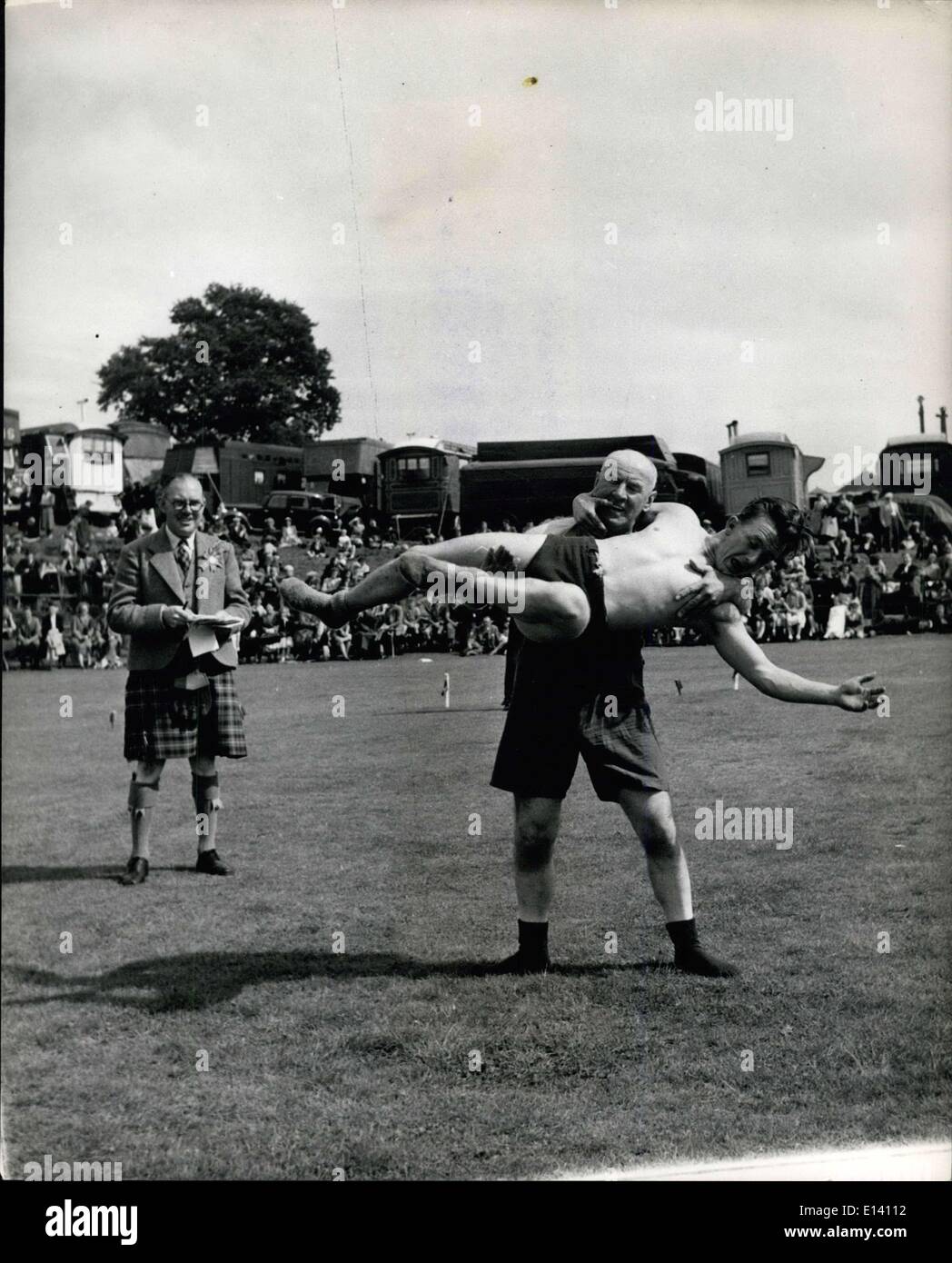 Mar. 31, 2012 - Crieff Highland gathering at Market Park, Crieff. Laurence McGregor, aged 59, the oldest competitor, of Dunfermline, winning the Catch-as-Catch-Can wrestling event. He is twirling Donald Wilson of Dunblane round and round. Stock Photo