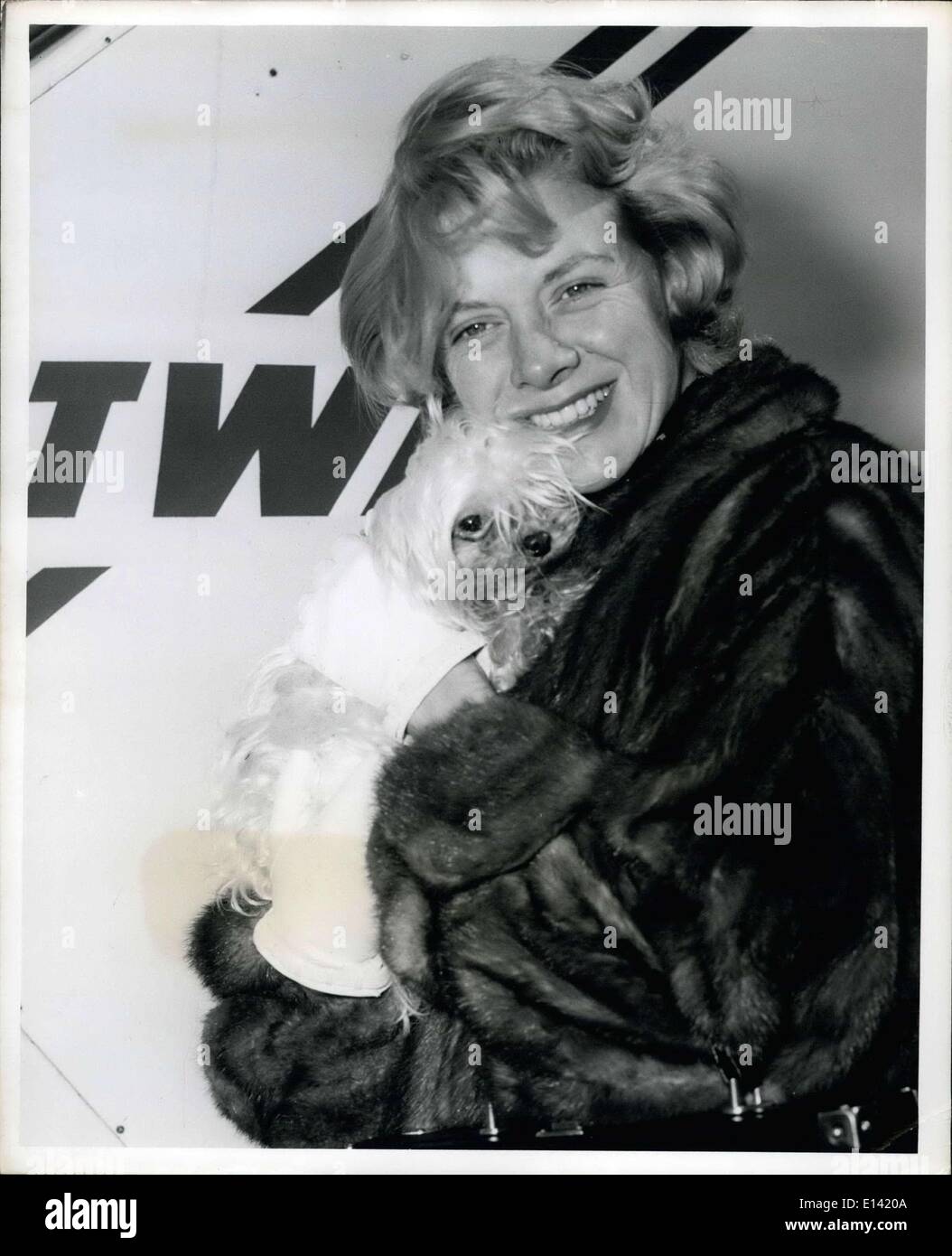 Mar. 31, 2012 - Songbird Rosemary Clooney, Her Hair Blowing In The Breeze, Takes A Moment To Have Her Picture Taken With Her Pet ''Schnookie'' Prior To Boarding A TWA Jetstream To Los Angeles. Miss Clooney, The Wife Of Actor-Director Jose Ferrer And The Mother Of Four Ranging In Age From 4 Months To 4 Years, Is Returning To Her Family Following A Three Week Visit In Town. Stock Photo
