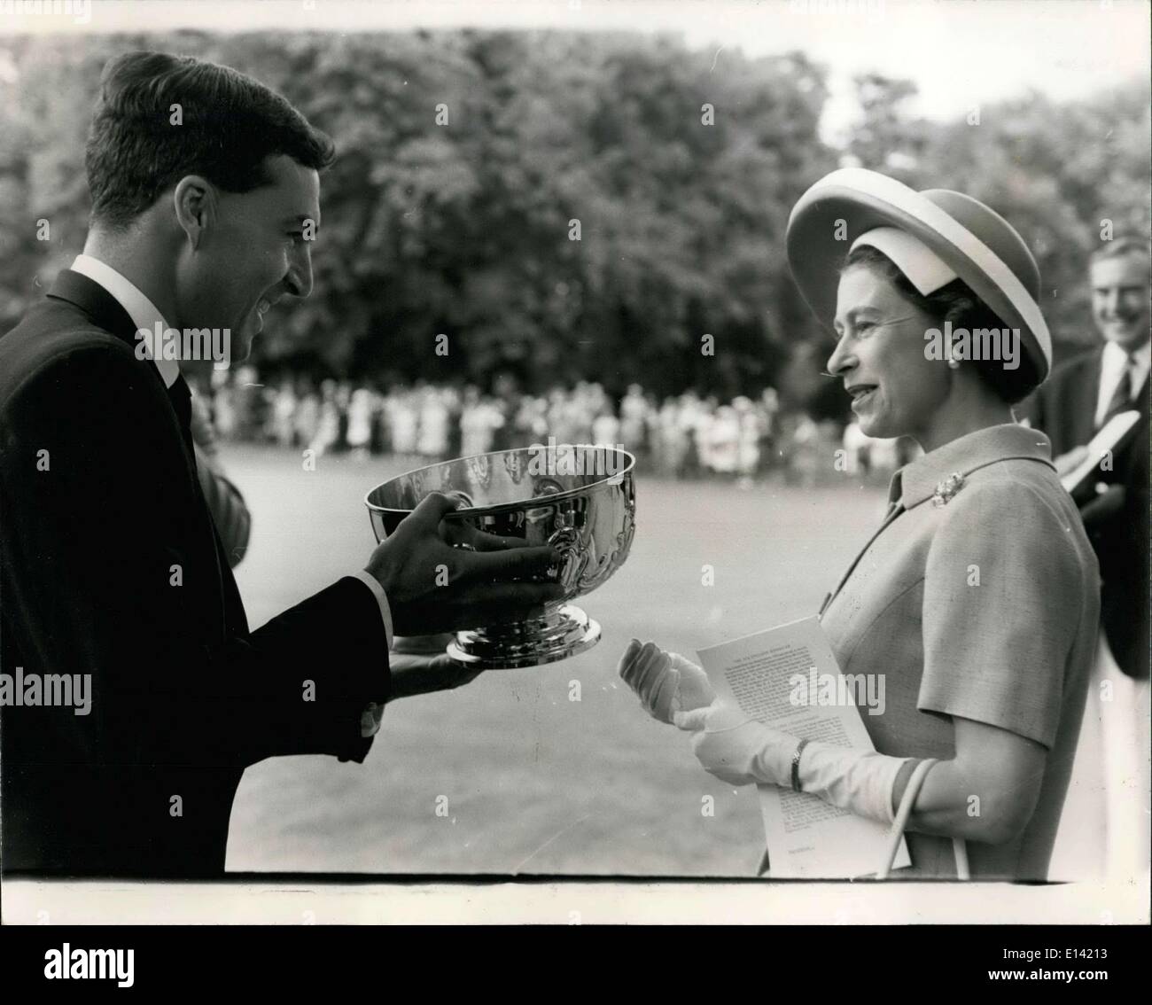Mar. 31, 2012 - Queen Attends Croquet Championships: This morning the Queen attended the Croquet Association's Centenary All-England Tournament final at Hurlingham Club. Photo shows The Queen presents a cup to Lt Commander Sinclair after he had won final of the All-England Centenary Handicap, at Hurlingham Club today. Stock Photo