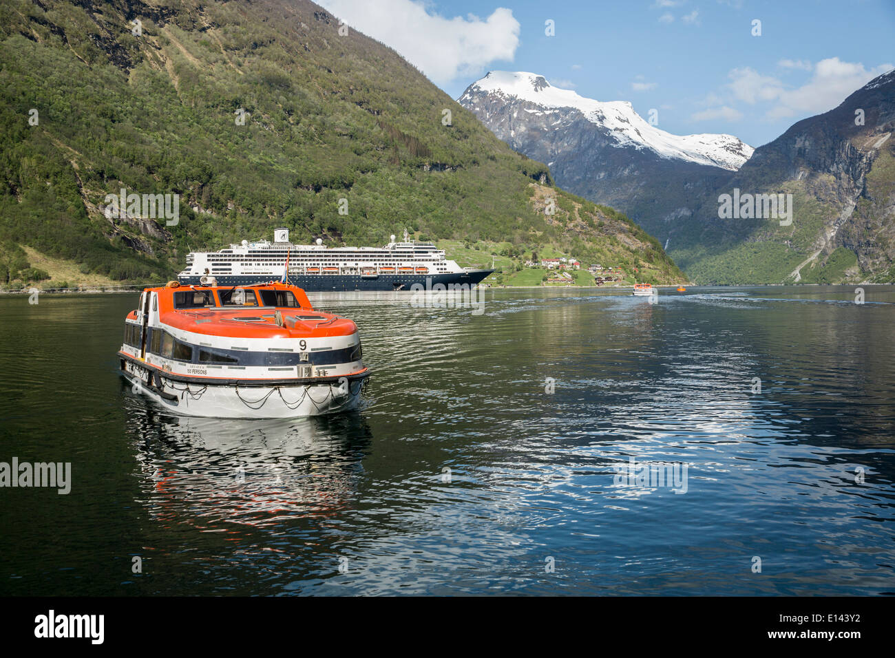 Norway, Geiranger, Geiranger fjord. Village and mountains. Cruise ship MS Rotterdam from Holland America line. Tender boats Stock Photo