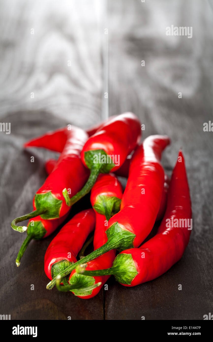 Red chilli pepper on wooden table background Stock Photo - Alamy