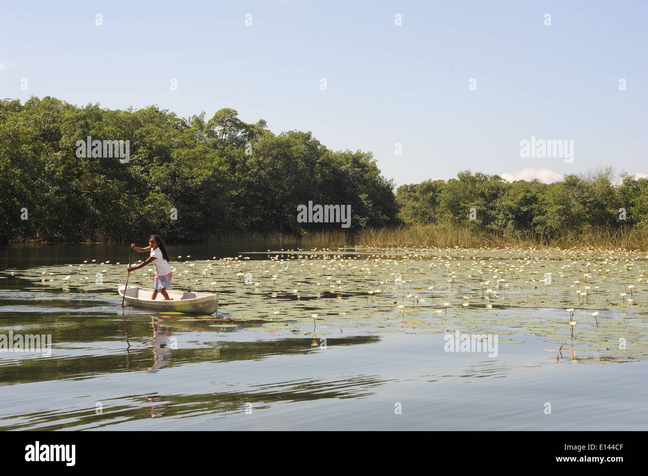 Girl on canoe at isla de las flores on river Dulce near Livingston on Guatemala Stock Photo