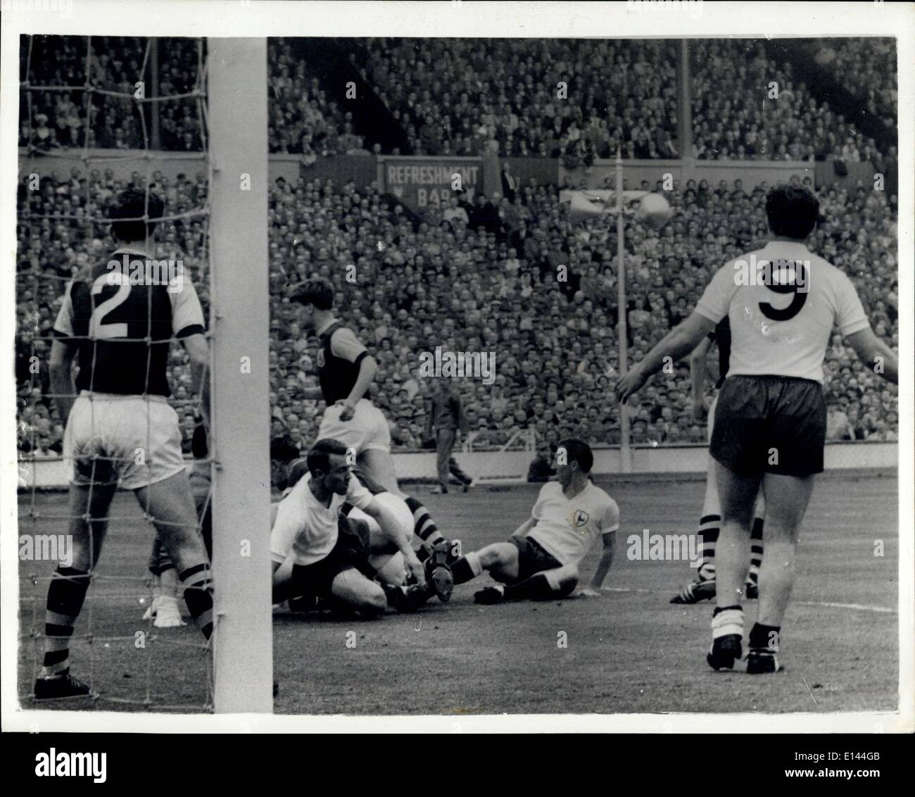 Apr. 04, 2012 - Tottenham Wins FA Cup 3-1: Tottenham Hotspur won the FA Cup for the second year running today when then defeated Burnley 3-1 at Wembley. Photo shows At Burnley goal, No. 2 John Angus, Burnley's right-back, watches Tottenham's Greaves (inside-left) and Cliff Jones (outside-left) on ground after an attack. In-the penalty area No. 9 is Spurs centre-forward Bobby Smith. Stock Photo