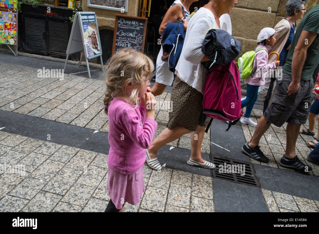 little girl lost in crowd Stock Photo