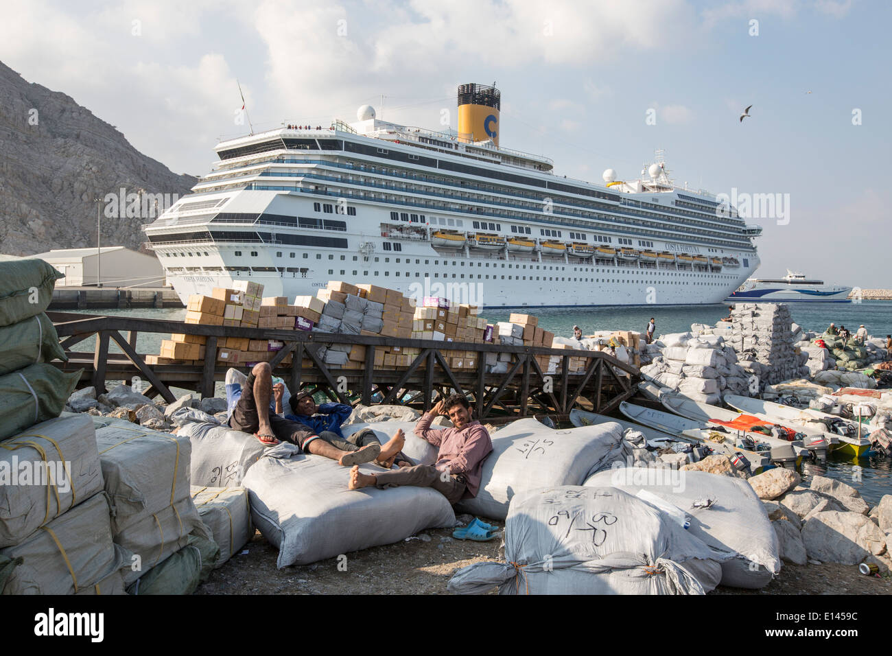 Oman, Khasab, Harbor, Iranian smugglers bringing agricultural products to Oman with small boats. Costa Fortuna cruise ship Stock Photo