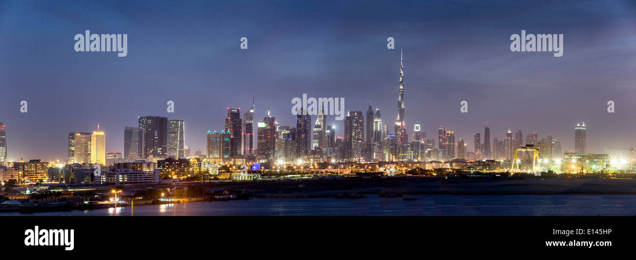 United Arab Emirates, Dubai, Financial city center skyline with Burj Khalifa, the highest building in the world. Twilight Stock Photo