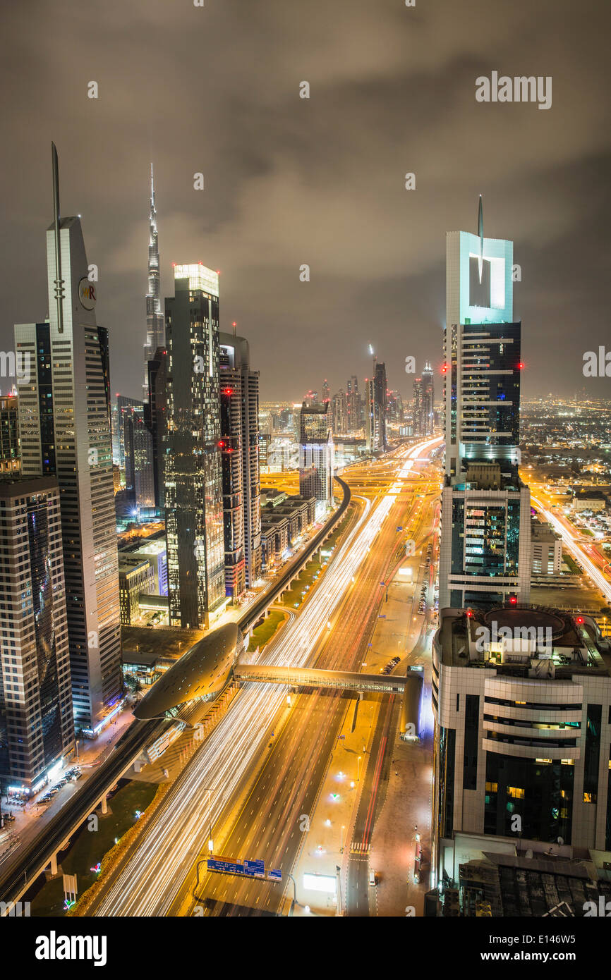 United Arab Emirates, Dubai, Sheikh Zayed Road crosses the financial city center with Burj Khalifa, Night Stock Photo