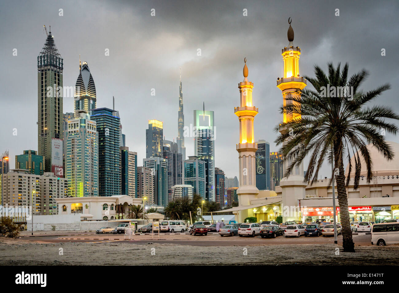 United Arab Emirates, Dubai, Financial city center skyline with Burj Khalifa, highest building in the world. Mosque. Twilight Stock Photo