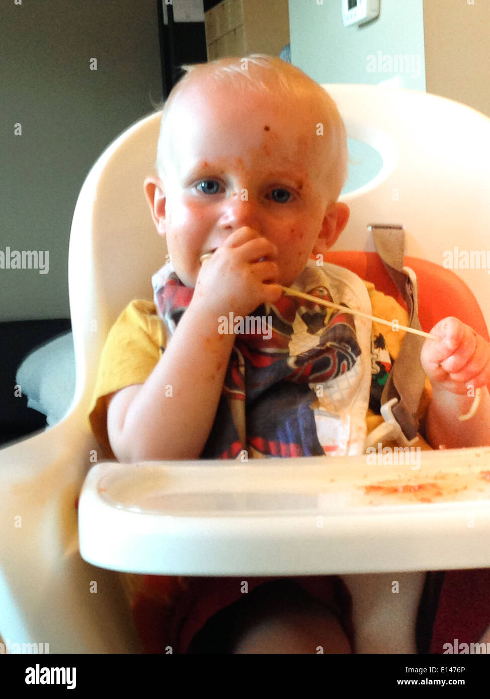 Baby eating in high chair - Smartphone Captured Stock Image