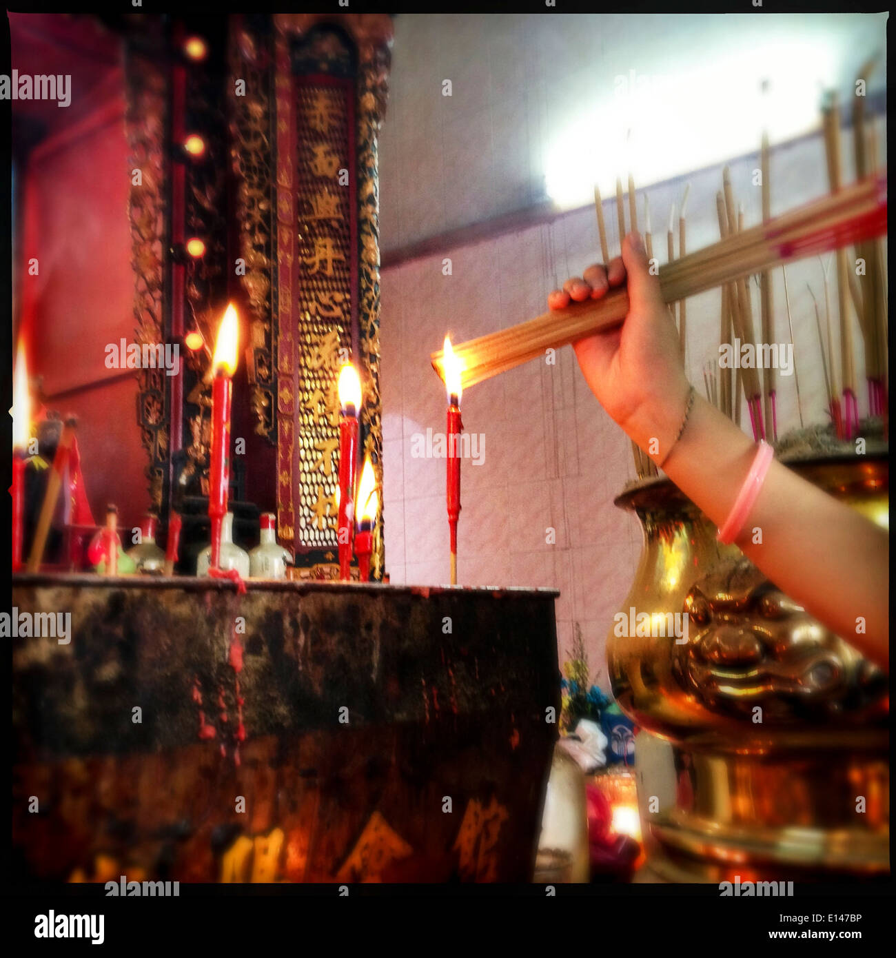 Caucasian woman burning incense at Chinese New Year celebration - Smartphone Captured Stock Image