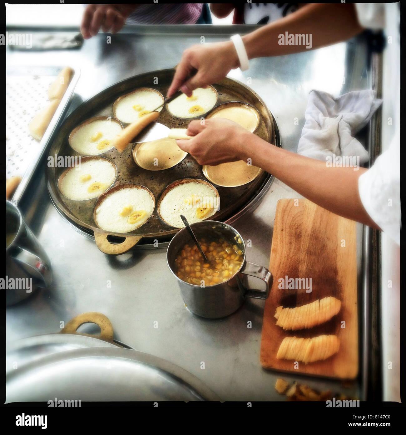 Chef making banana pancakes in commercial kitchen - Smartphone Captured Stock Image
