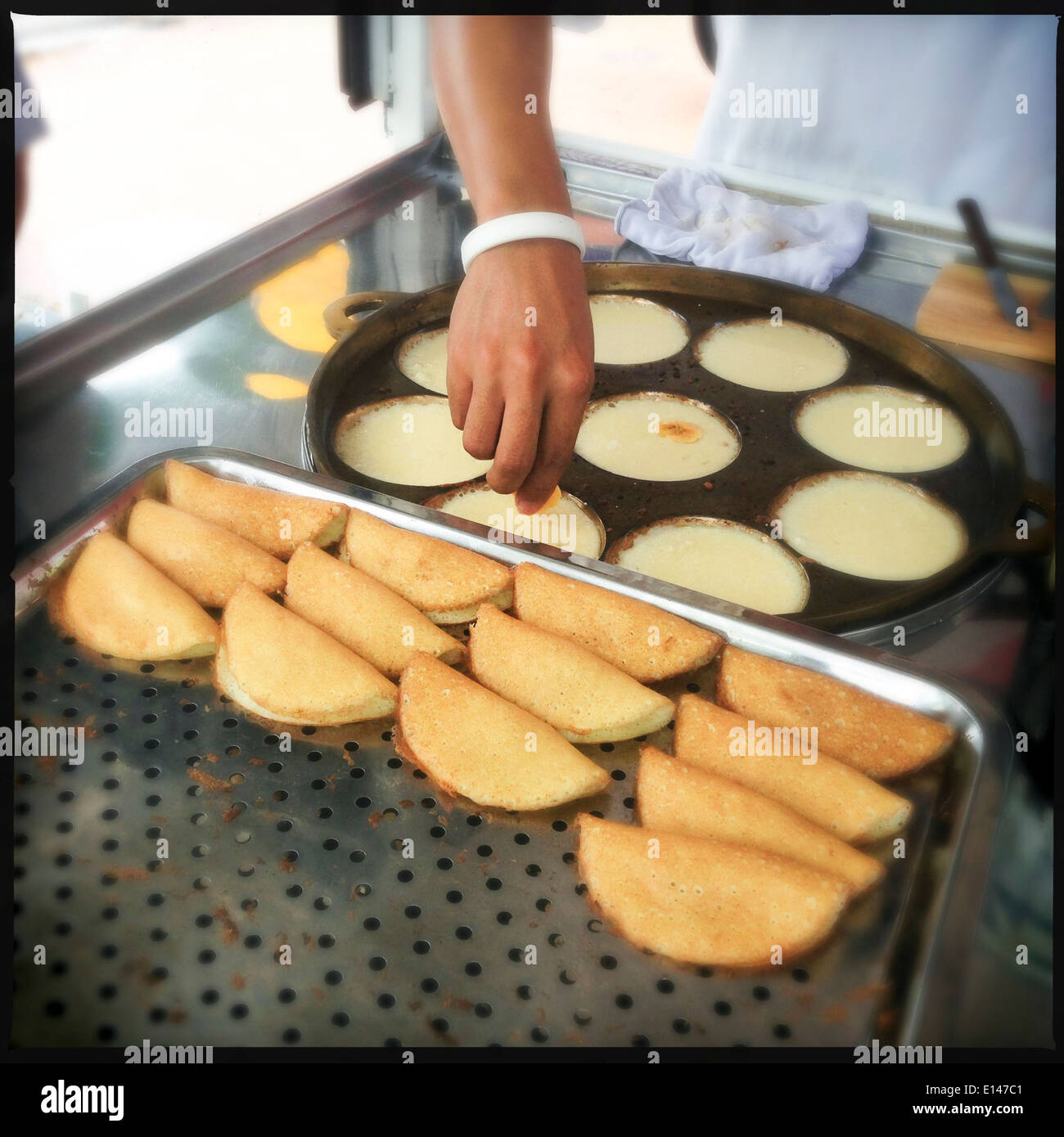 Chef making banana pancakes in commercial kitchen - Smartphone Captured Stock Image