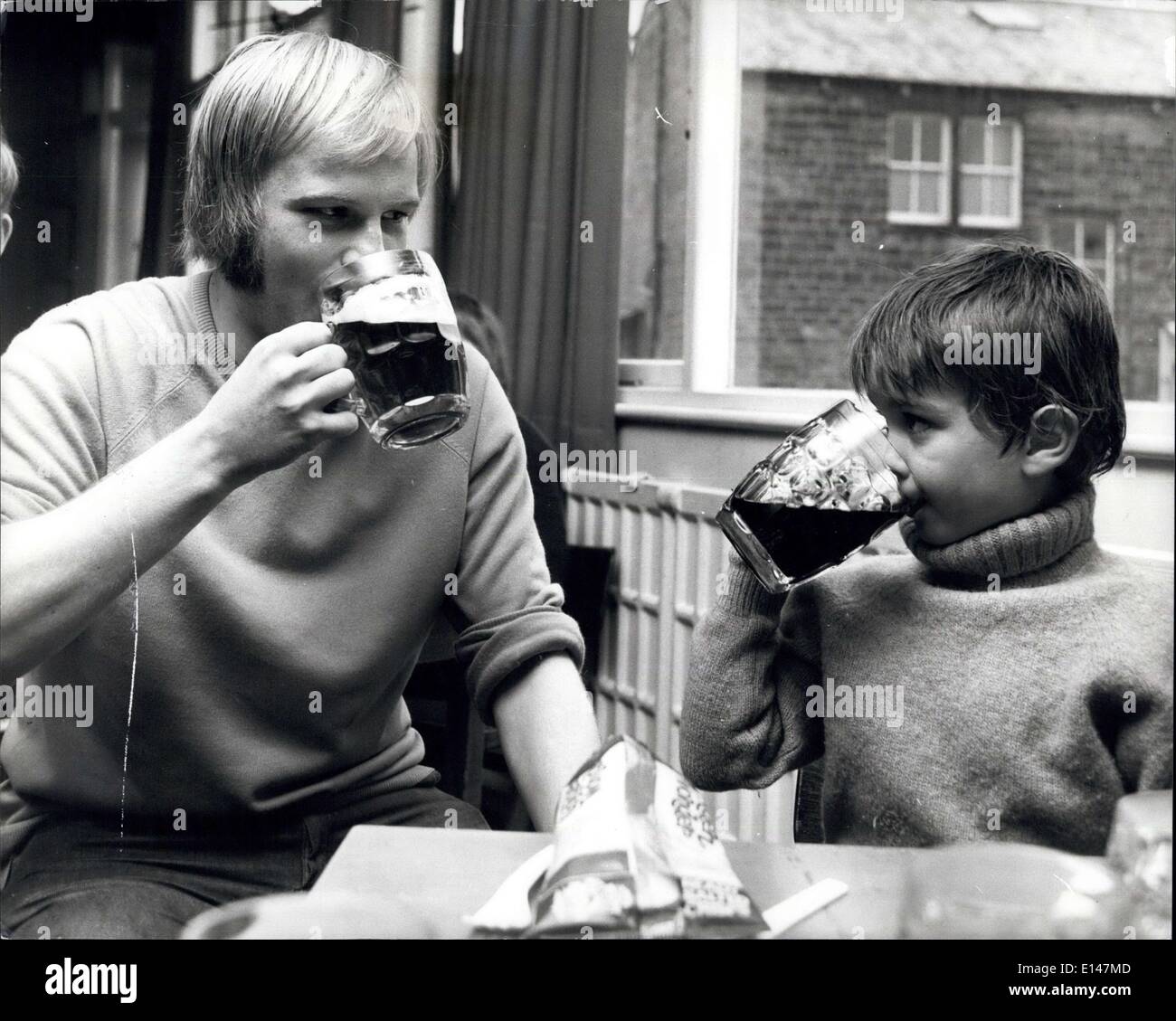 Apr. 17, 2012 - Six-year-old Andrew Born sinks a pint with Peter Fitton after training. ''Mine's Coke'' says Andrew. Stock Photo
