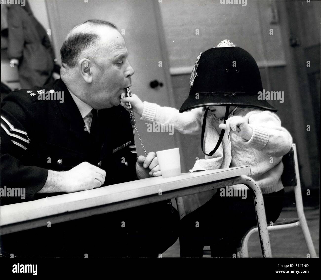 Apr. 17, 2012 - ''You blow....'' the policeman's whistle is a familiar sound to this child. ne Pictures U Stock Photo