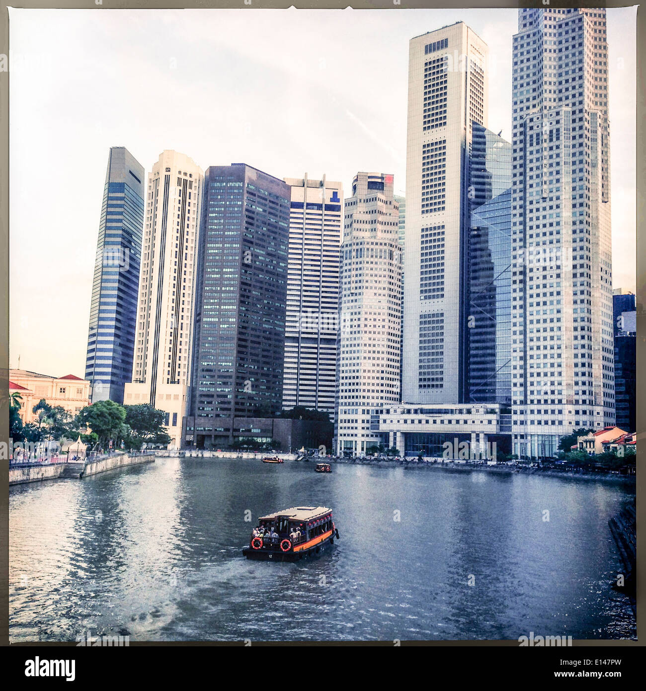 Boat floating on Singapore waterfront, Singapore, Republic of Singapore Stock Photo