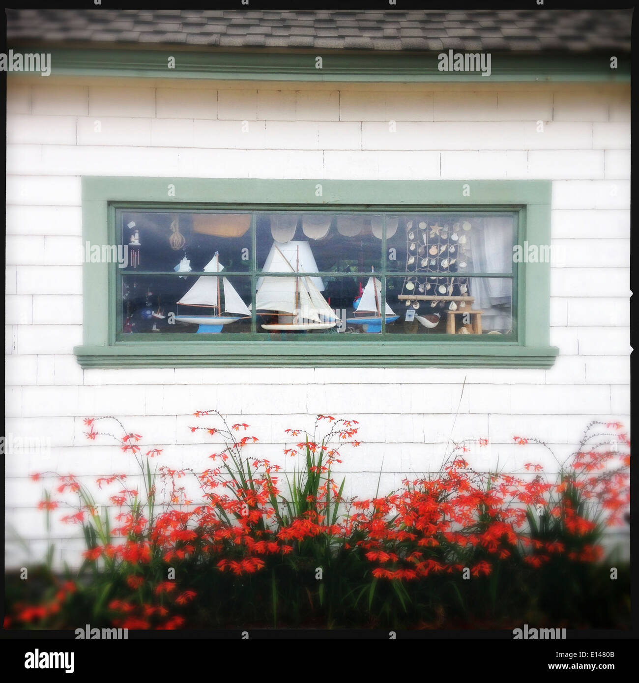 Decorative sailboats in window of house - Smartphone Captured Stock Image