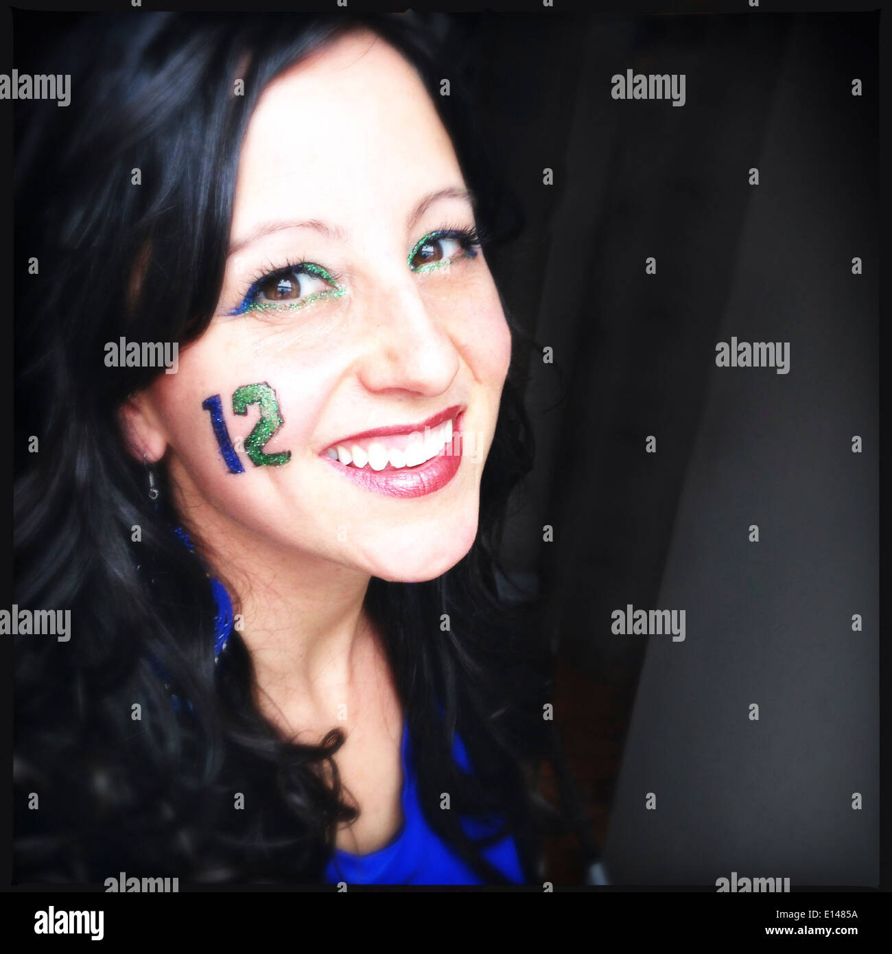 Caucasian woman wearing decorative number 12 on cheek - Smartphone Captured Stock Image