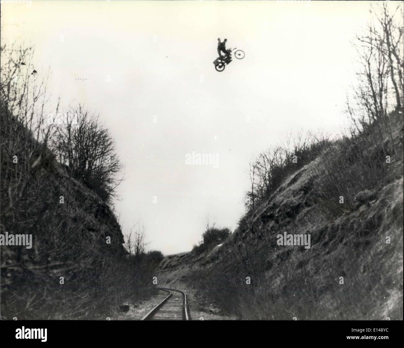 Apr. 17, 2012 - Eddie Kidd on his flying machine: 18 year old Eddie Kidd, excelled even his own daredevil exploits, when he soared 145 feet across a railway cutting with a dummy strapped to the seat of his bike. The daring jump across the railway track 80 feet below him, took place at Shepton Mallet in Somerset, was part of a scene from a new war film. Stock Photo