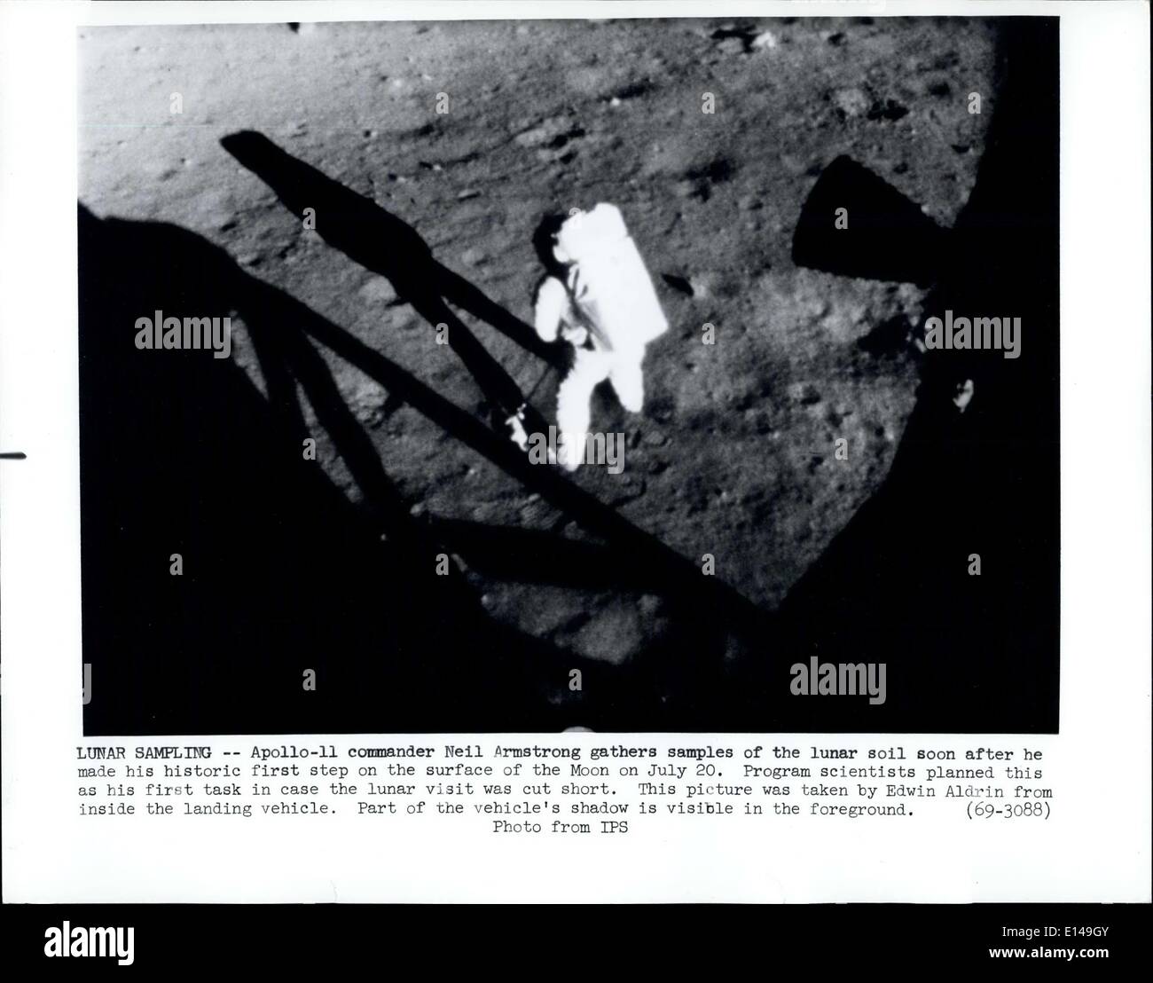 Apr. 17, 2012 - Lunar Sampling: Apollo 11 commander Neil Armstrong gathers samples of the lunar soil soon after he made his historic first step on the surface of the Moon on July 20. Program scientists planned this as his first task in case the lunar visit was cut short. Photo Shows was taken by Edwin Aldrin from inside the landing vehicle. Part of the vehicle's shadow is visible in the foreground. Stock Photo