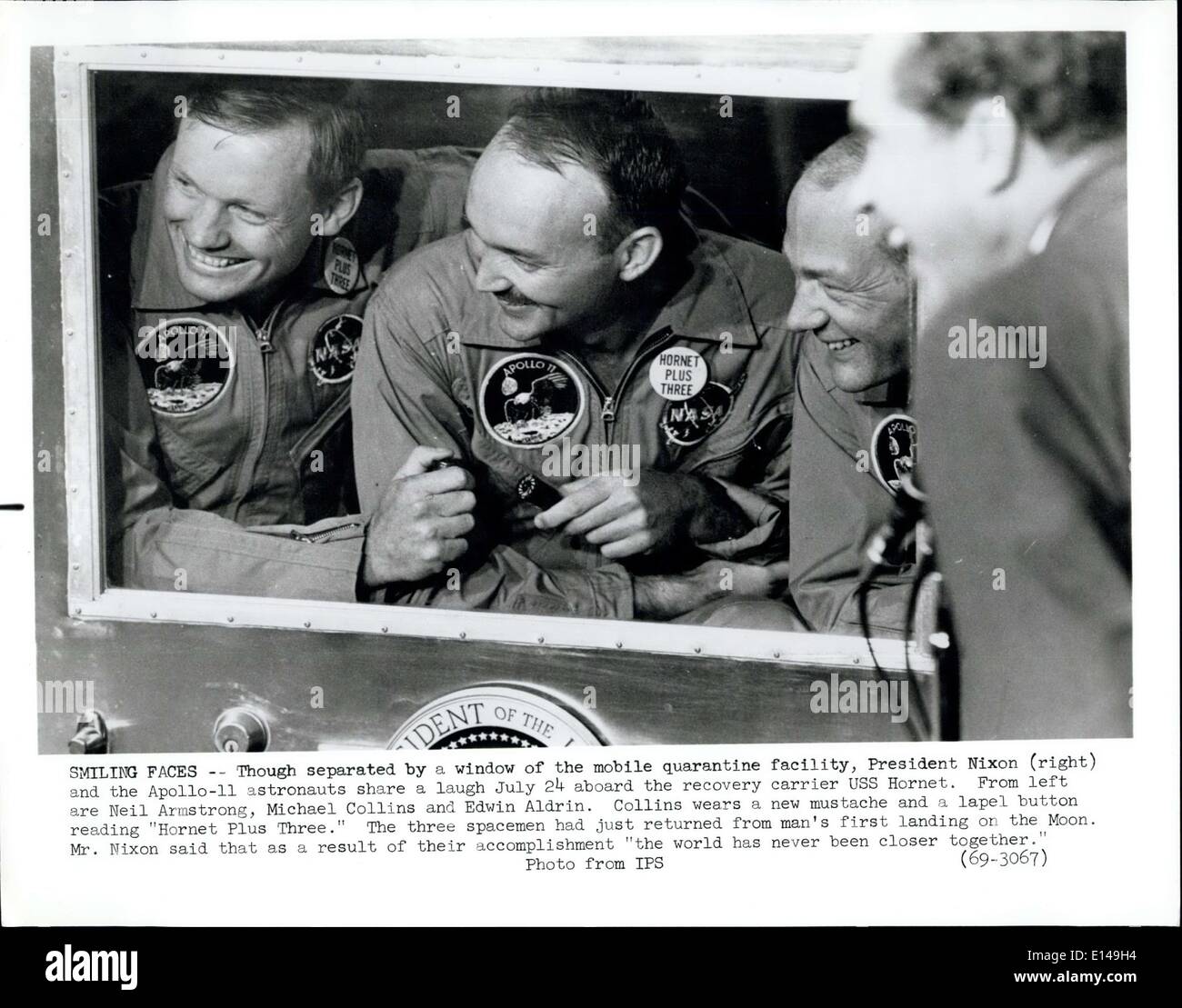 Apr. 17, 2012 - Smiling Faces: Though separeted by a window of the mobile quarantine facility, President Nxon (right) and the Apollo 11- astrounaut share a laugh July 254 aboard the recovery carrier USS Hornet, From left are BNeil Armstrong, Michael Cillins and Edwing Aldrin. Collins wears a new mustches and a lapel button reading ''Hornet Plus Three''. The three spacemen had just returned form man's firs landong onm the Moon. Mr. Nixon said trhatv as a result of their accomplishment ''the world has nevr been closer together' Stock Photo