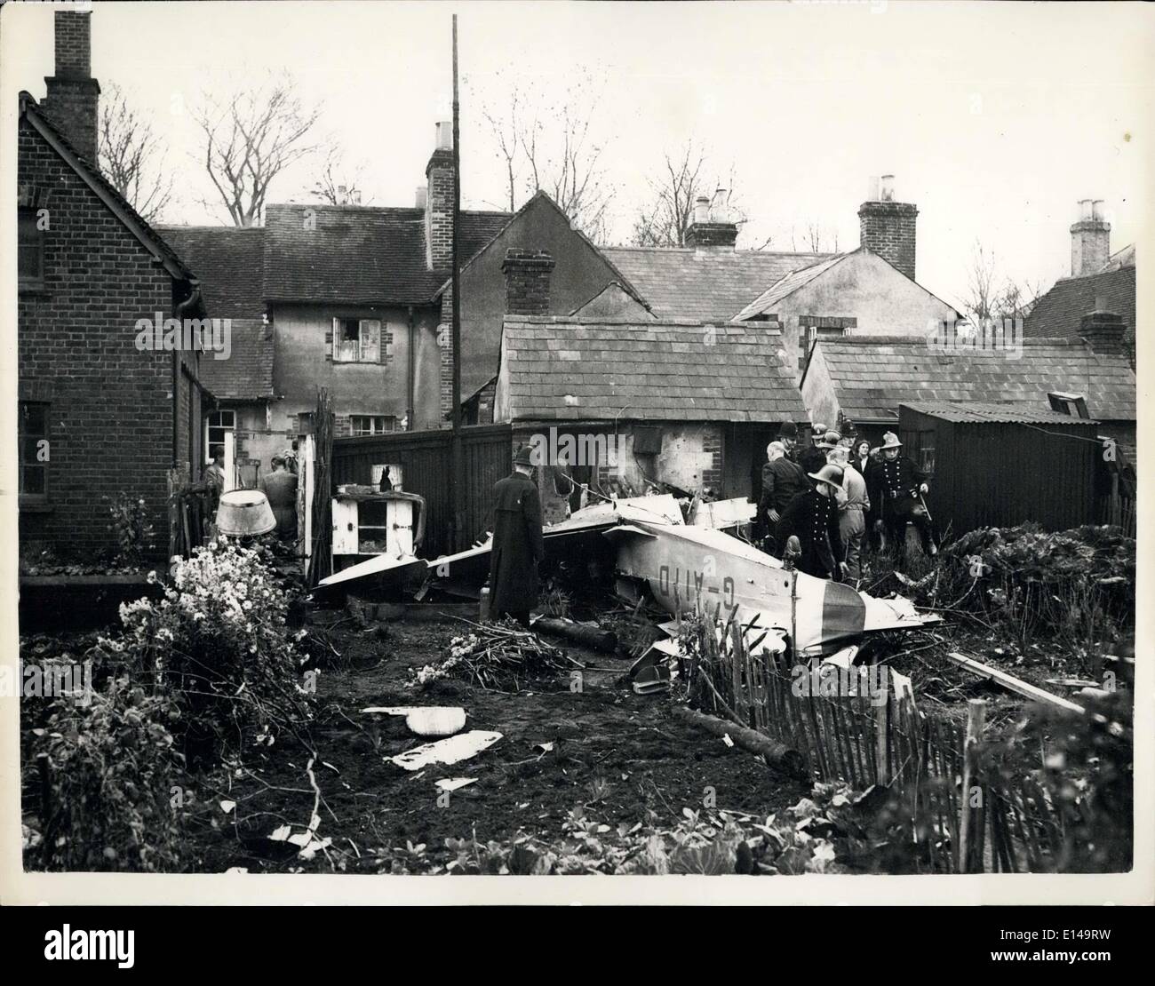 Apr. 17, 2012 - Woman trapped in her garden when plane crashes two killed: The two occupants of a Miles Magister aircraft Mr. A. Holmes and Mr. W. Webster were killed when their machine crashed into the bank garden of the home of Mrs. Daisy Morris at Nutfield near Godalming, Surrey yesterday&gt; Mrs. Morris had gone into the garden to collect some clothes from the clothes line when the machine crashed immediately behind her trapping against the wall. Has she gone into the garden just a few seconds later she would probably have been killed Stock Photo