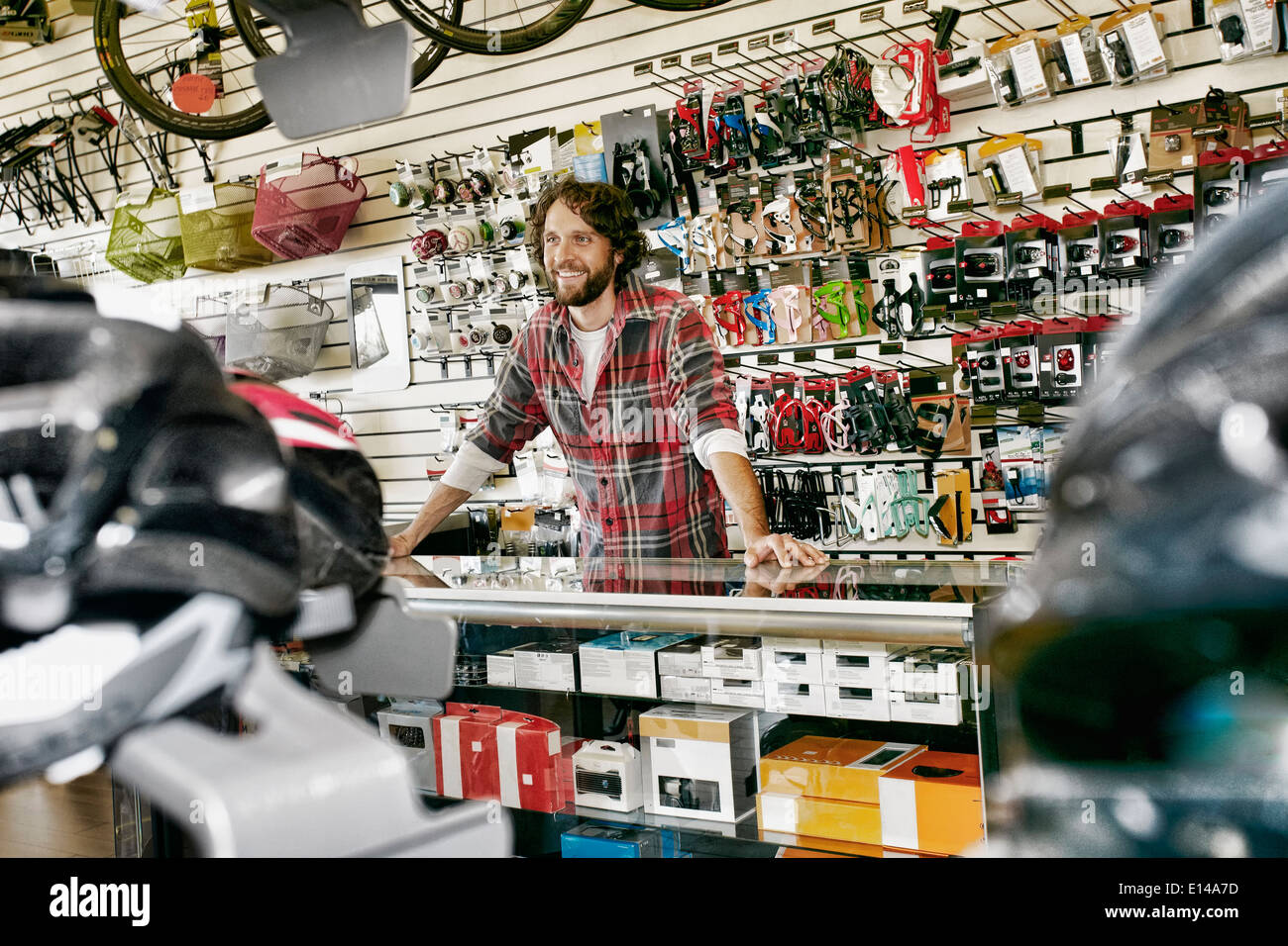 Caucasian man working in bicycle shop Stock Photo